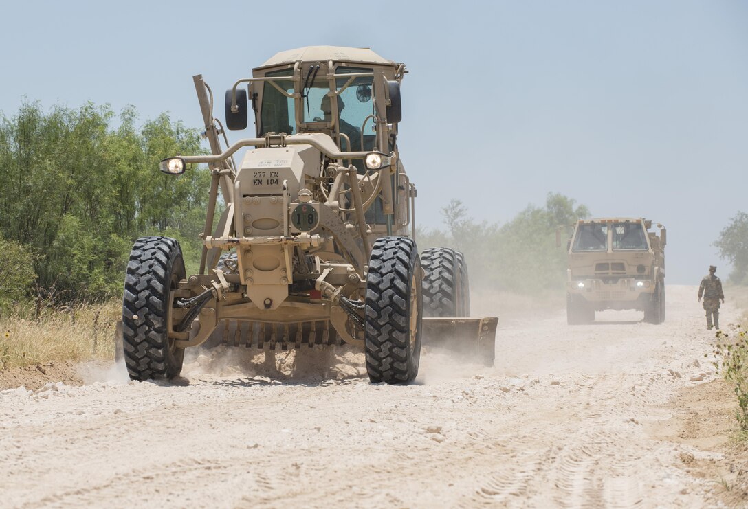 Soldiers with the 277th Engineer Company based in San Antonio repair a 2.5-mile stretch of dirt road in a colonia near Laredo, Texas, as part of an Innovative Readiness Training mission June 23, 2017. Nearly 200 Army Reserve Soldiers are participating in the mission along the Texas-Mexico border.  (Photo by Sean Kimmons)