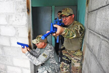 Joint Security Forces subject matter experts from Joint Task Force-Bravo demonstrate how to clear rooms to local police officers at La Paz, Honduras, June 20, 2017. During the Subject Matter Expert Exchange where the JSF members helped participants practice communicating with their team members using commands and coordination as they approached the target together.