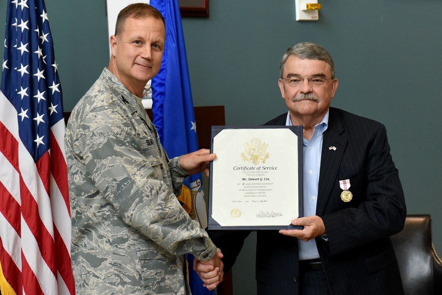 Col. Joseph P. Slavick, 4th Mission Support Group commander, presents Stewart G. Cox, 4th Mission Support Group civilian deputy commander, with a Certificate of Service, June 22, 2017, at Seymour Johnson Air Force Base, North Carolina. Cox retired after 40 years of service to the Air Force both on active duty and a civilian employee. (U.S. Air Force photo by Airman 1st Class Victoria Boyton)
