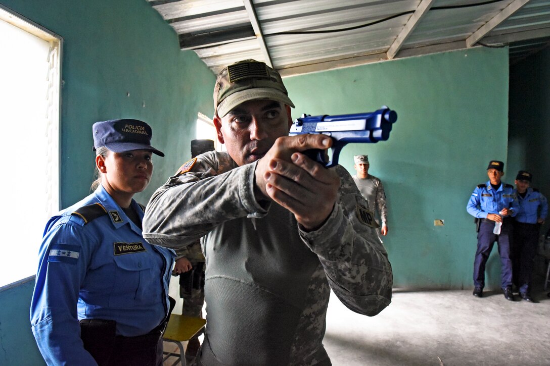 U.S. Army Sgt. Jesse Ruiz, Joint Task Force-Bravo Joint Security Forces explain tactical maneuvers to clear rooms to a team of local police officers at La Paz, Honduras, June 20, 2017.  Ruiz was the primary instructor during the Subject Matter Expert Exchange where the JSF members helped participants practice communicating with their team members using commands and coordination as they approached the target together.