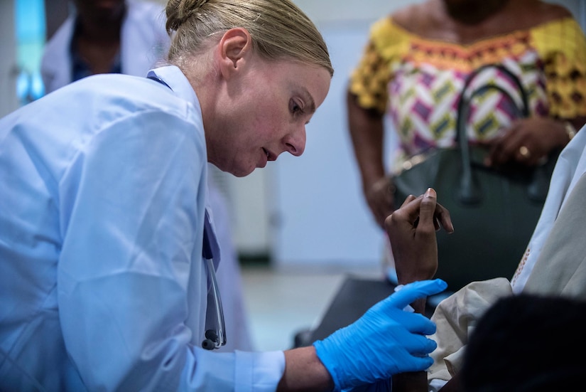 Army 1st Sgt. Donna Wilson, a practicing nurse specialist, removes an intravenous catheter from a patient during Medical Readiness Training Exercise 17-4 at Hospital D’Instruction Des Armees in Libreville, Gabon, June 19, 2017. Army photo by Staff Sgt. Shejal Pulivarti