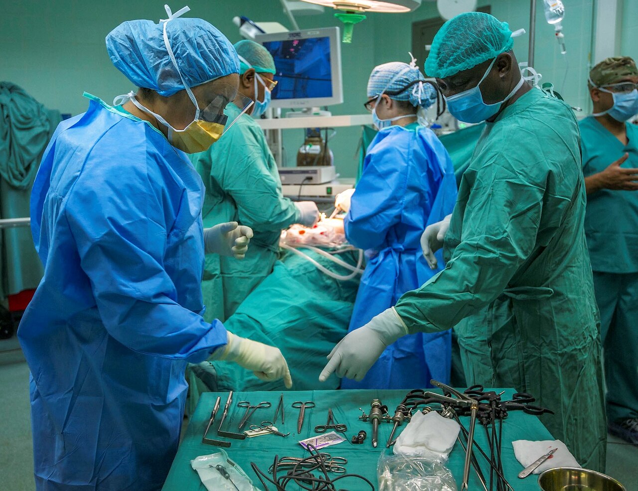Army Staff Sgt. Jennifer Singh, an operating room technician, works with a Gabonese military medical professional to perform a gall bladder surgery during Medical Readiness Training Exercise 17-4 at Hospital D’Instruction Des Armees in Libreville, Gabon, June 19, 2017. Army photo by Staff Sgt. Shejal Pulivarti