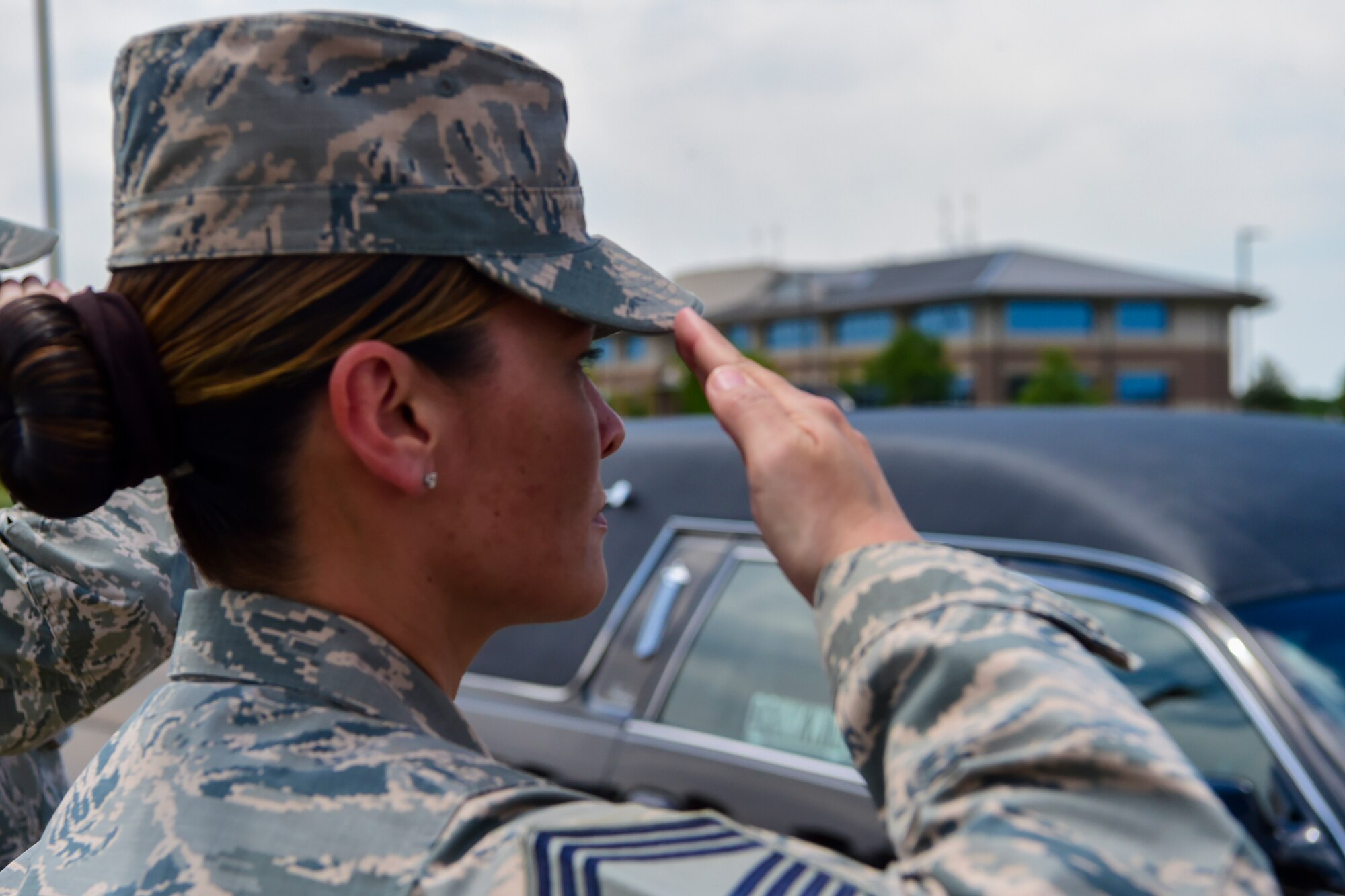 Chief Master Sgt. Billy Baber, superintendent, Future Systems and Operations at Headquarters Air Reserve Personnel Center, renders a final salute to Major Elgin Ross, chief, Total Force Service Center, assigned to HQ ARPC, June 27, 2017, on Buckley Air Force Base, Colo. Ross tragically passed away after becoming unresponsive while conducting his physical training test on June 16. The Buckley community paid their last respects to Ross and his family at a funeral procession on Aspen Street, from the Mississippi Gate to the 6th Avenue Gate. (U.S. Air Force photo by Senior Airman Madison Ratley/Released)