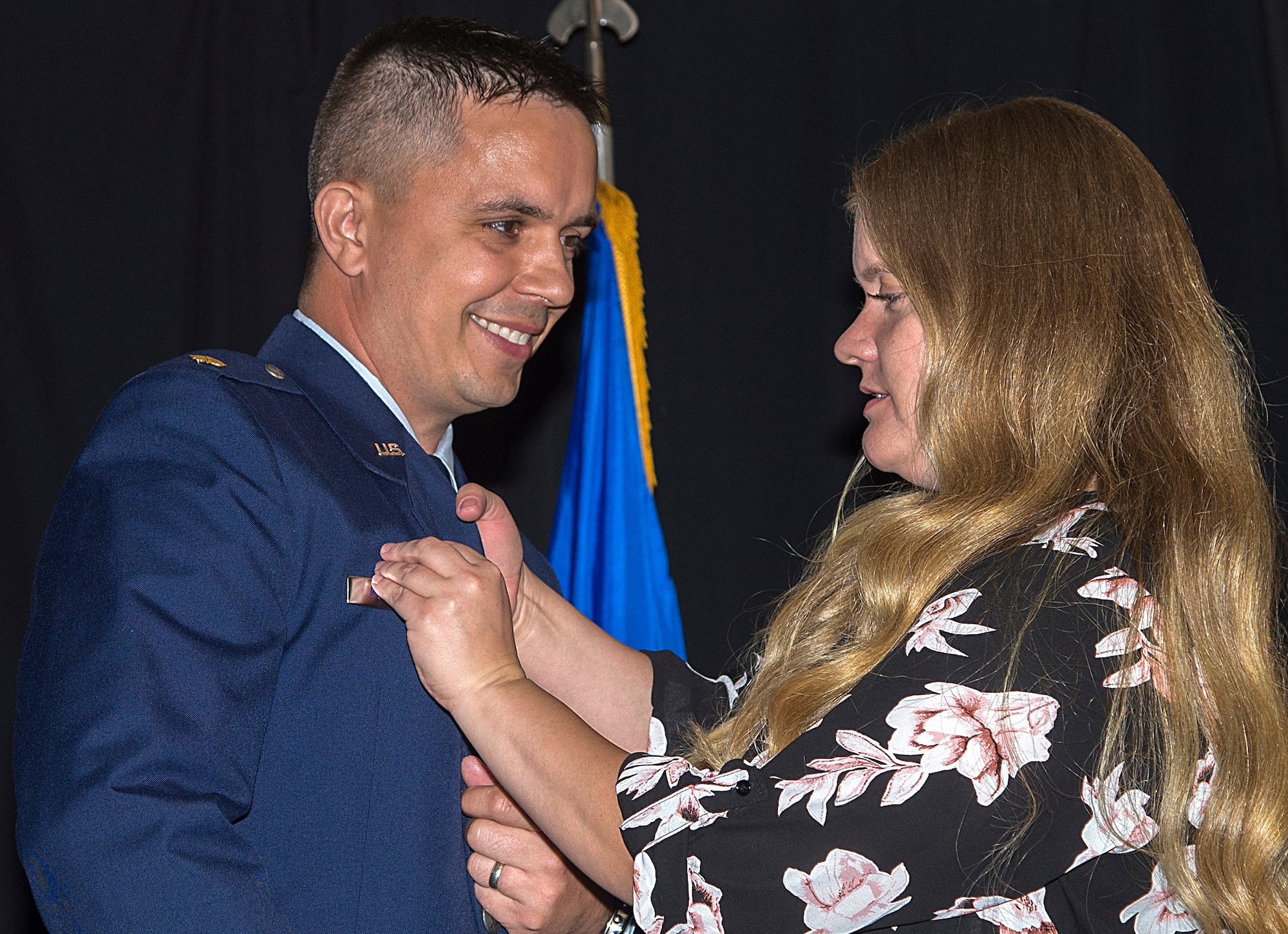 Lindsay Peterson, right, wife of the new 71st Comptroller Squadron commander, Maj. Steven Peterson, pins on her husband’s commander insignia during a change-of-command ceremony held June 16 in the Vance Club at Vance Air Force Base, Oklahoma. (U.S. Air Force photo/ Airman 1st Class Taylor Crul)