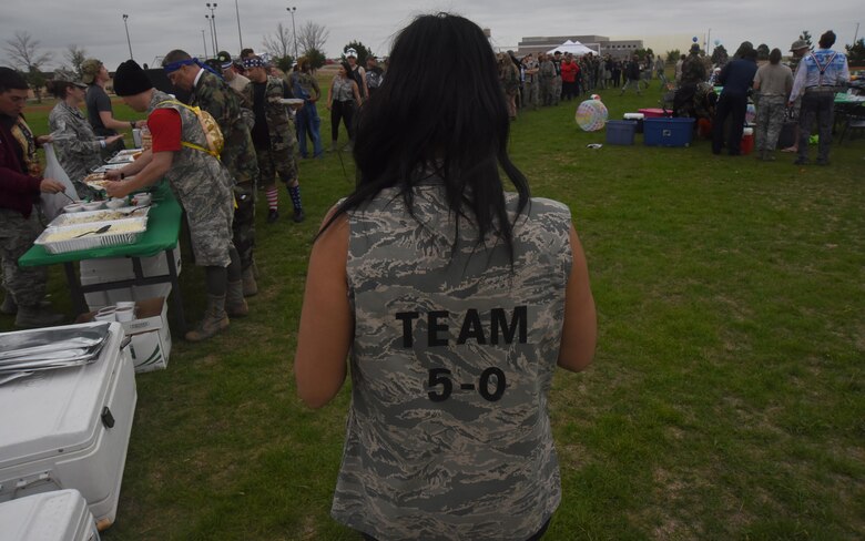 First Lieutenant Sarah D’Alessandro, 50th Force Support Squadron, shows off her “Team 5-0” spirit during the 50th Space Wing’s combat dining out event at Schriever Air Force Base, Colorado, Friday, June 23, 2017. Airmen wore a variety of military and space-themed outfits during the event. (U.S. Air Force photo/Airman 1st Class William Tracy)