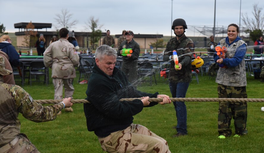 Col. Scott Angerman, 50th Network Operations Group commander, gets drenched participating in a tug-of-war competition during the 50th Space Wing’s combat dining out at Schriever Air Force Base, Colorado, Friday, June 23, 2017. Those not involved in competition played a role distracting and disrupting throughout organized competitions (U.S. Air Force photo/Airman 1st Class William Tracy)