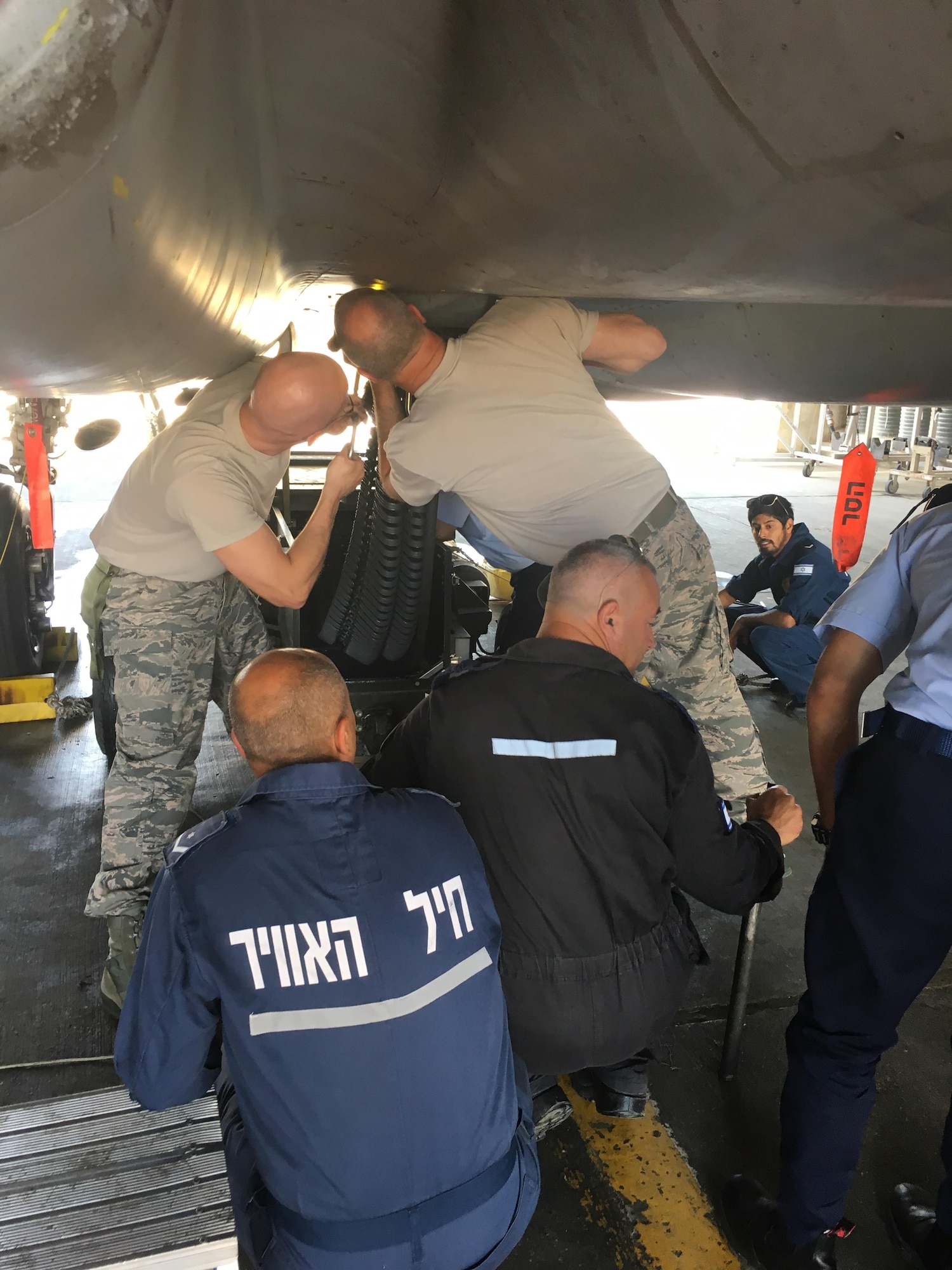 Master Sgts. Brian Monson and Greg Carte look over the feeding mechanism for the 20mm Gatling rotary gun which can fire at a rate of 6,000 rounds a minute, during a trip to Israel to help train their airmen on maintenance techniques, May 16, 2017. The Kingsley troops were asked to participate in the bilateral training because the jets originally belonged to the 173rd Fighter Wing and were transferred to Israel in an historic agreement last September. (Photo courtesy Master Sgt. Brian Monson)