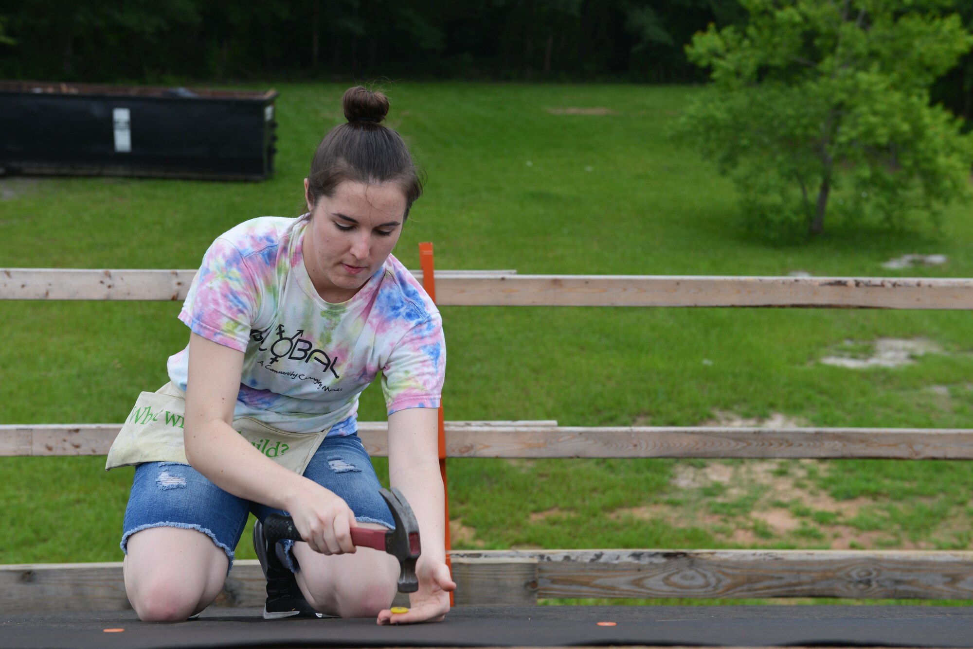 U.S. Air Force 1st Lt. Kimberlie Kirkpatrick, 20th Aircraft Maintenance Squadron, Shooters Aircraft Maintenance Unit assistant officer in charge, steadies a nail before hammering into a rooftop in Sumter, S.C., June 23, 2017. In honor of Lesbian, Gay, Bisexual and Transgender Pride Month, 20th Fighter Wing Airmen volunteered to help build a home for Habitat for Humanity. (U.S. Air Force photo by Airman 1st Class Destinee Sweeney)