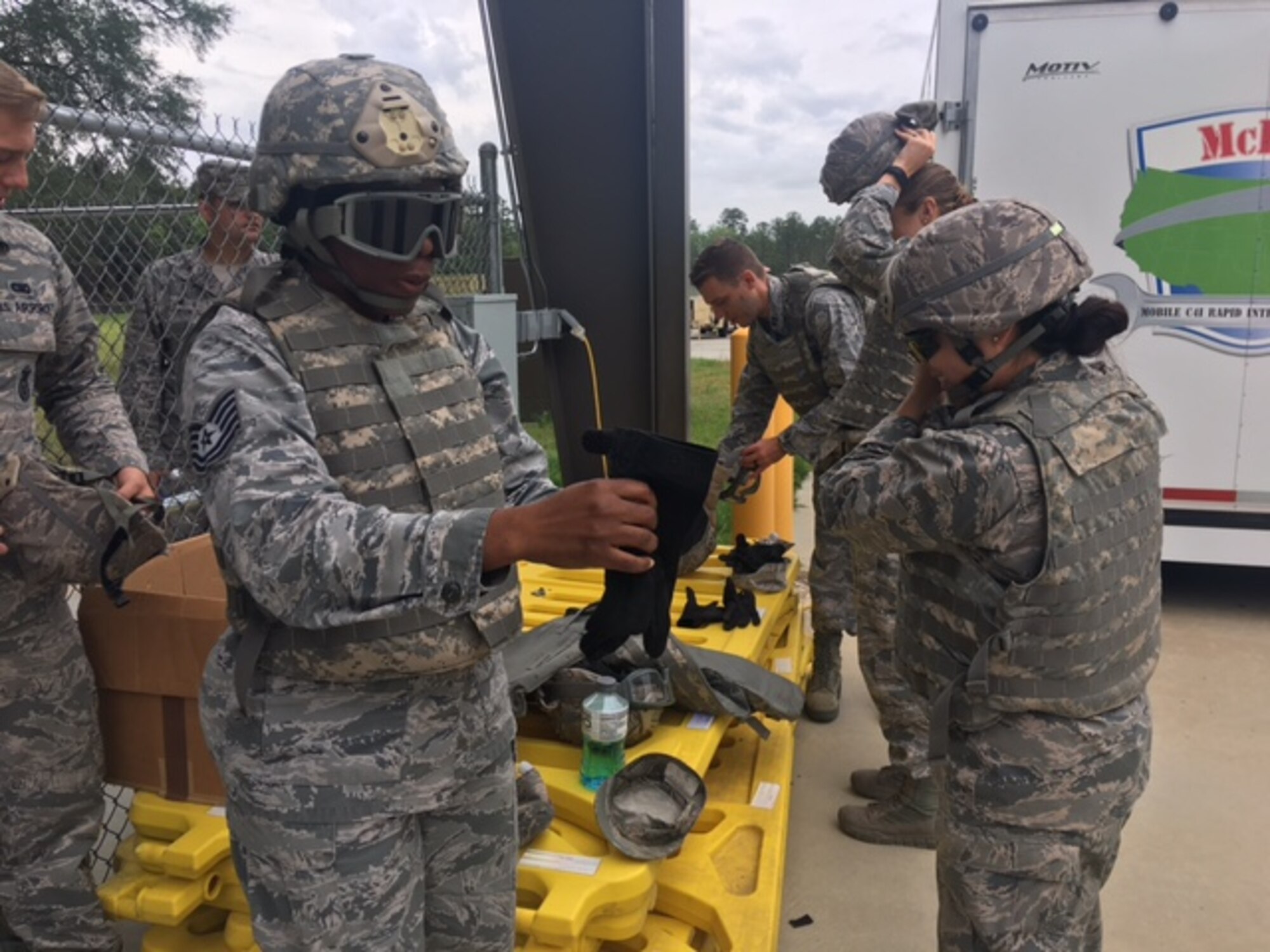 Class members from Emerge Moody put on protective gear prior to experiencing a Mine-Resistant Ambush Protected vehicle egress assistance trainer May 2, 2017, at Moody Air Force Base, Ga. Emerge Moody spent the day with the 820th BDG learning about the organization’s mission and capabilities. (Courtesy Photo)