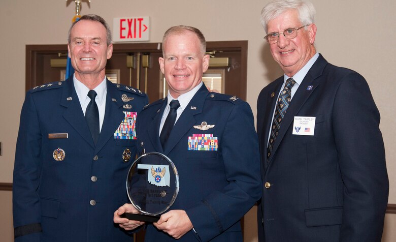 Col. Darrell Judy, center, the 71st Flying Training Wing commander, accepts the hardware for the Oklahoma State Air Force Association Military Unit of the Year for 2017, at a banquet in Tulsa June 24. The award was presented by Lt. Gen. Darryl Roberson, the Air Education and Training Command commander, left, and Mark Tarpley, the Oklahoma State AFA president. (U.S. Air Force photo/ Tech. Sgt. James Bolinger)