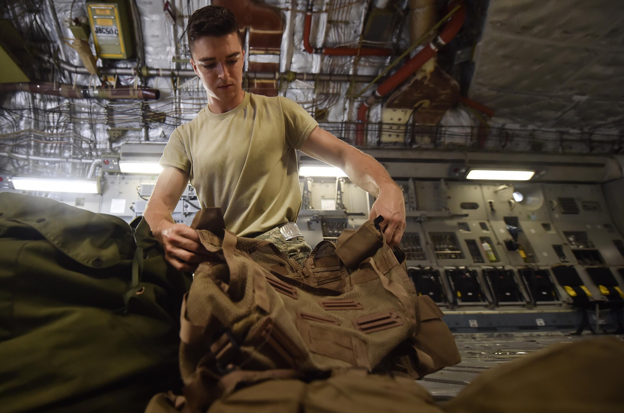 Airman 1st Class Travis Neal, 437th Operations Support Squadron aircrew flight equipment apprentice, packs survival vests and oxygen masks on board a C-17 Globemaster III as part of an inspection at Joint Base Charleston, S.C., June 22. Airmen assigned to the 437th OSS AFE flight ensure that aircrew equipment including helmets, oxygen masks, life rafts, and parachutes are safe and ready for aircrew members to operate. (U.S. Air Force photo by Staff Sgt. Christopher Hubenthal) 