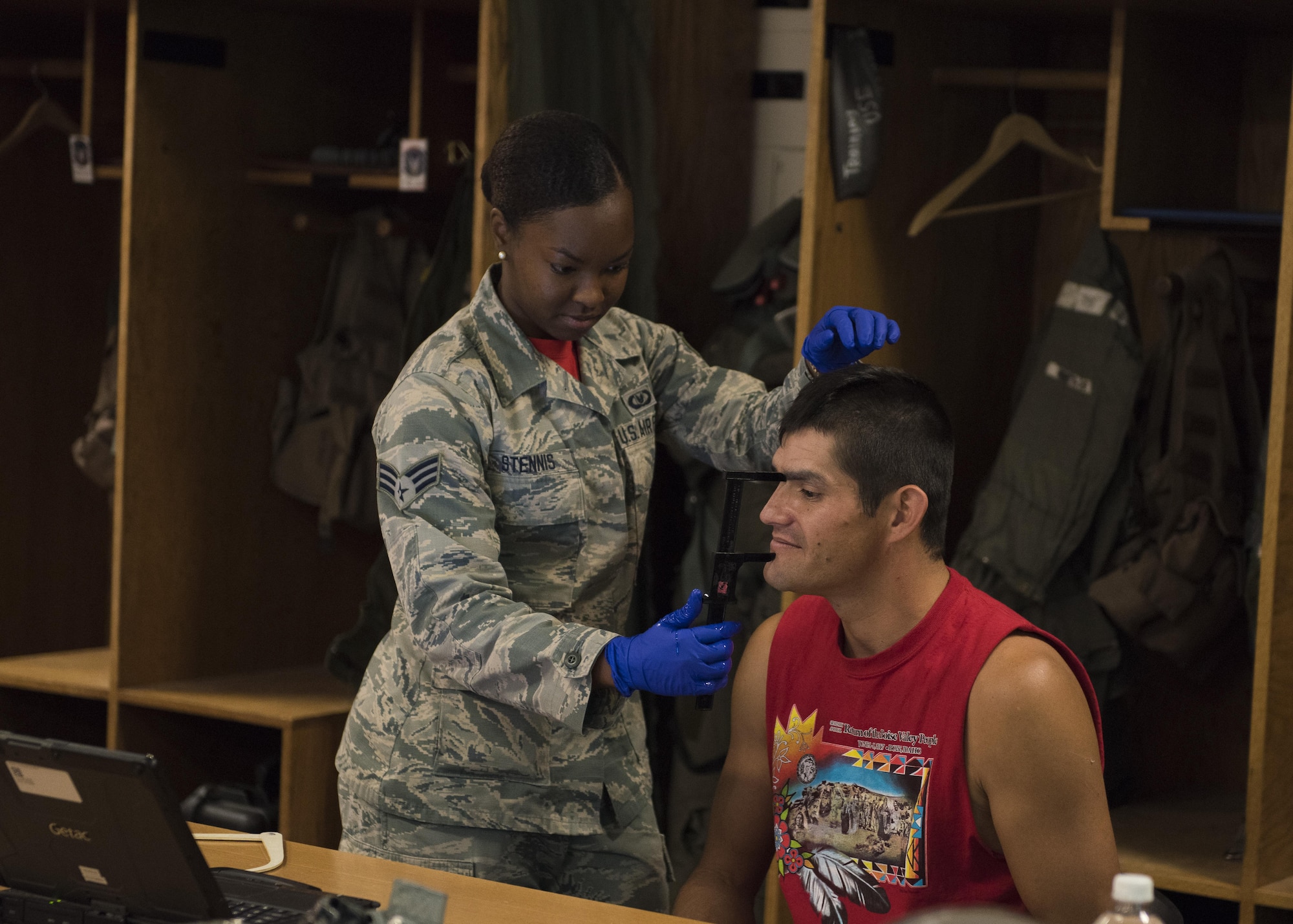 Senior Airman Kayla Stennis, 366th Operations Support Squadron aircrew flight equipment journeyman, fits Vice Chairman Buster Gibson of the Shoshone-Paiute Tribes of the Duck Valley Indian Reservation for a helmet, June 16, 2017, at Mountain Home Air Force Base, Idaho. Gibson needs the helmet to fit securely for his orientation flight, to ensure his safety. (U.S. Air Force photo by Airman 1st Class Alaysia Berry/Released)