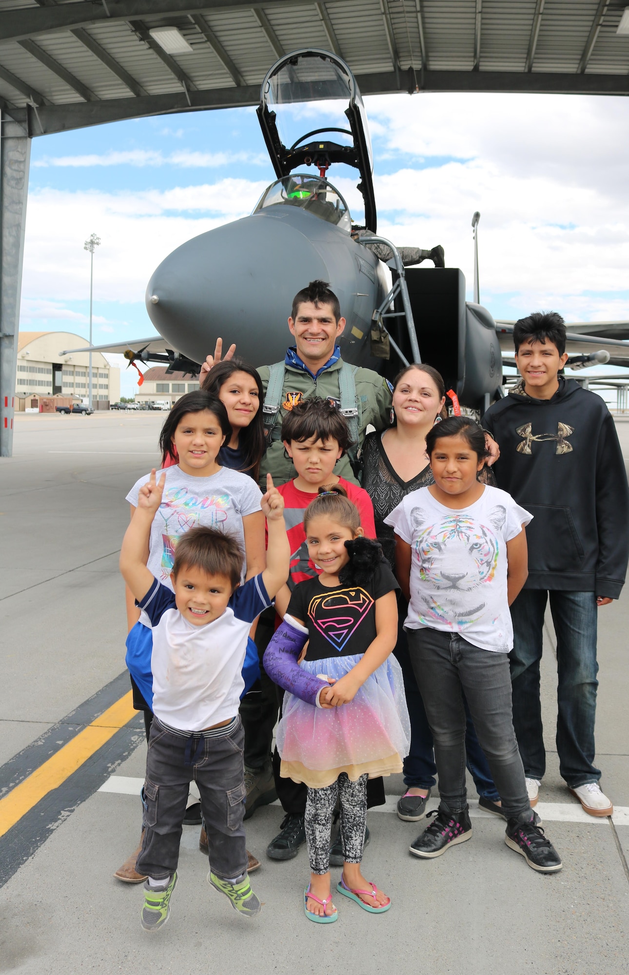 Vice Chairman Buster Gibson of the Shoshone-Paiute Tribes of the Duck Valley Reservation poses for a photo with his family at Mountain Home Air Force Base, Idaho, June 16, 2017. During the flight Gibson was able fly over the flightline and wave to the business council members and family. (U.S. Air Force Photo by Lt. Col. John Jacobus)