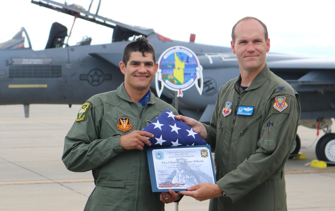 Col. Jefferson O'Donnell, 366th Fighter Wing commander, and Vice Chairman Buster Gibson of the Shoshone-Paiute Tribes of the Duck Valley Reservation pose for a photo at Mountain Home Air Force Base, Idaho, June 16, 2017. Gibson was presented with a flight certificate and a U.S. flag that was flown over the base. (U.S. Air Force photo by Lt. Col. John Jacobus)