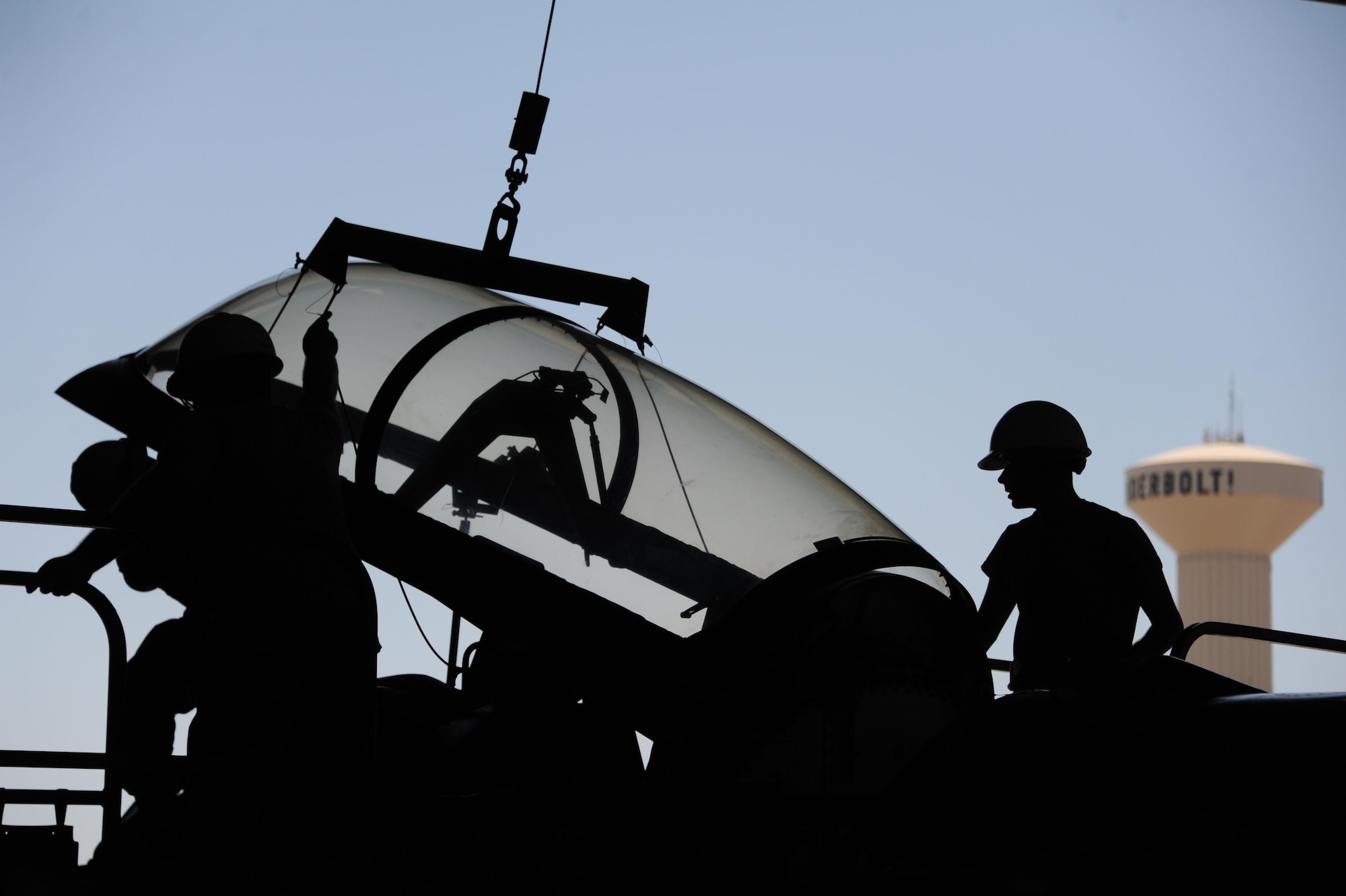 Airmen assigned to the 56th Component Maintenance Squadron hoist an F-16 Fighting Falcon canopy into the air June 26, 2017 at Luke Air Force Base, Ariz. Aircrew egress systems specialists maintain and repair items associated with aircraft escape and survival systems such as warning lights, emergency oxygen systems, canopies, lap belts and shoulder harnesses. (U.S. Air Force photo by Airman 1st Class Caleb Worpel)