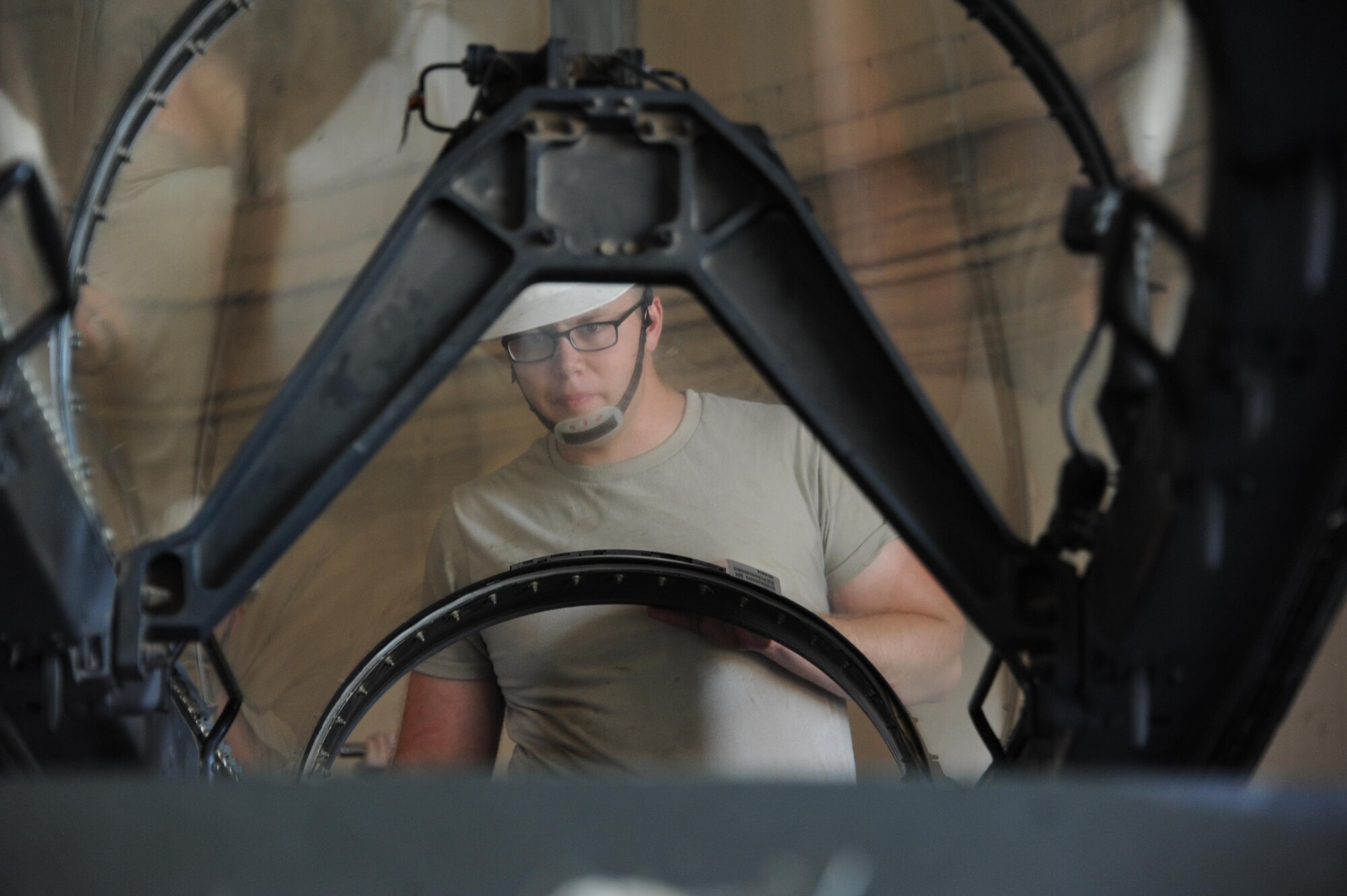 Airman 1st Class Zeb Chadwick, 56th Component Maintenance Squadron aircrew egress technician, lower an F-16 Fighting Falcon canopy onto a transport trailer June 26, 2017 at Luke Air Force Base, Ariz. The F-16 cockpit and its bubble canopy give the pilot unobstructed forward and upward vision, and greatly improved vision over the side and to the rear increasing pilot comfort and gravity force tolerance. (U.S. Air Force photo by Airman 1st Class Caleb Worpel)