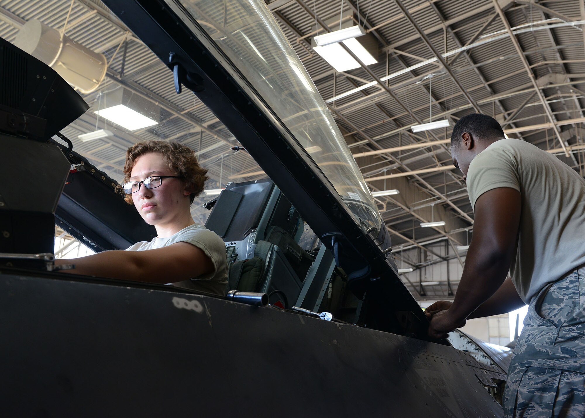 Airman 1st Class Raena Sedowski, 56th Component Maintenance Squadron aircrew egress technician, and Airman 1st Class Diamond Balock White, 56th CMS aircrew egress technician, prepare an F-16 Fighting Falcon for canopy and seat removal June 26, 2017, at Luke Air Force Base, Ariz. Aircrew egress technicians perform maintenance on warning lights, emergency oxygen systems, canopies, lap belts and shoulder harnesses. (U.S. Air Force photo by Senior Airman James Hensley)