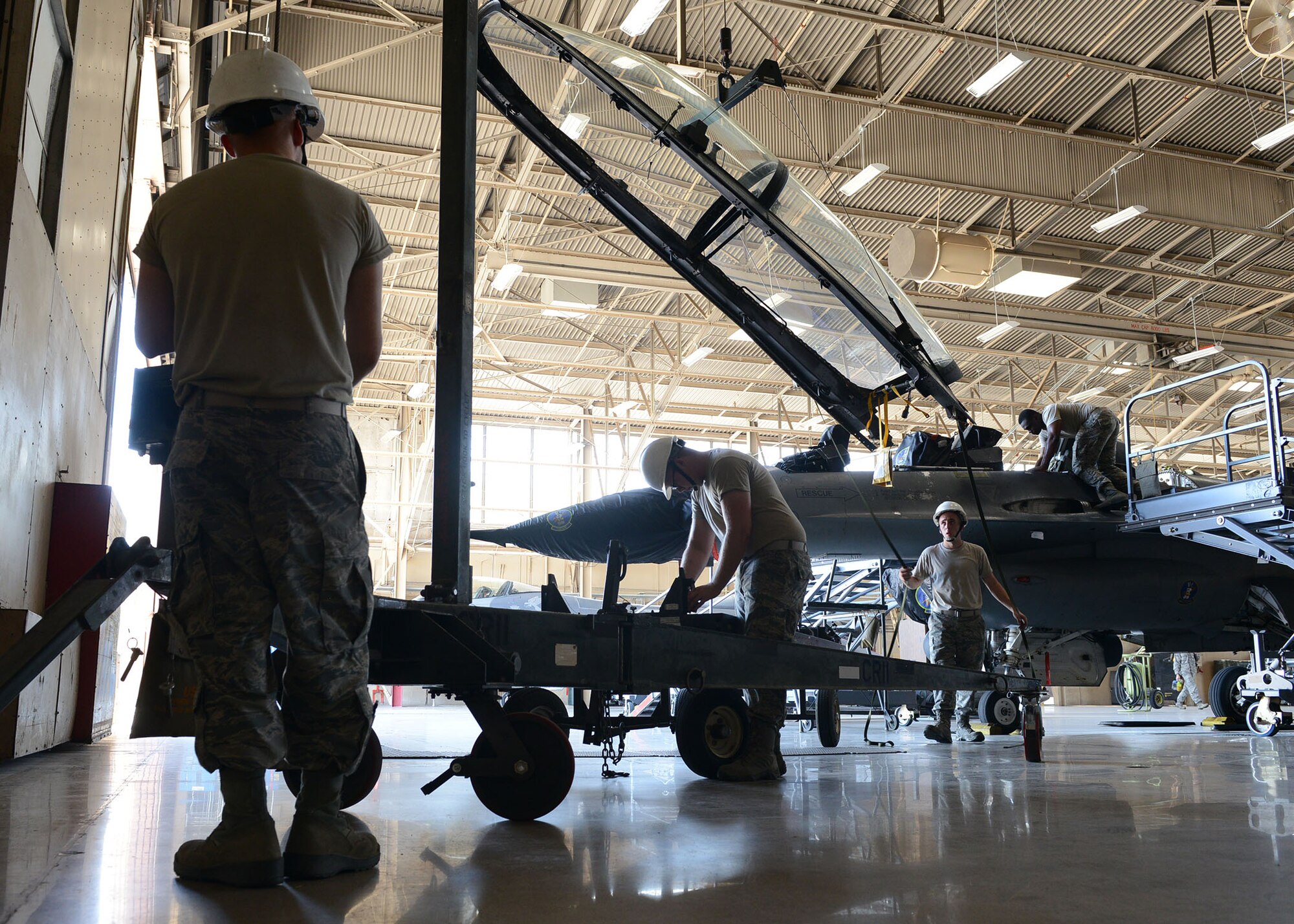 56th Component Maintenance Squadron Egress Airmen remove a canopy from an F-16 Fighting Falcon June 26, 2017, at Luke Air Force Base, Ariz. The egress Airmen take care of ejection seats and canopies for both the F-16 and F-35 Lightning II. (U.S. Air Force photo by Senior Airman James Hensley)