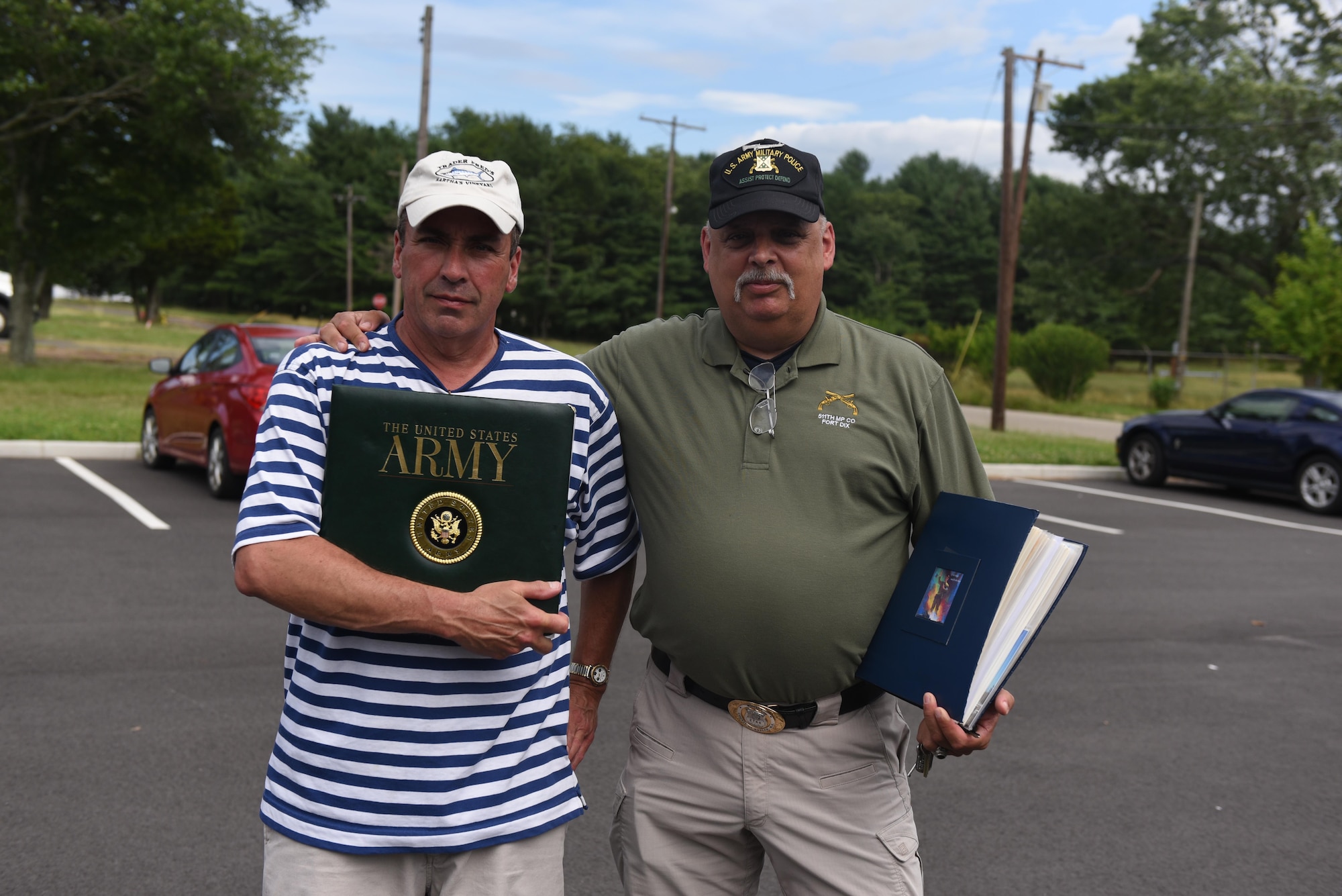U.S. Army veterans display photo albums of their time at then Fort Dix in the 1970s at Joint Base McGuire-Dix-Lakehurst, New Jersey, June 23, 2017. The tour included a visit to the unit's old barracks and a trip onto the ranges the MPs used to train on.