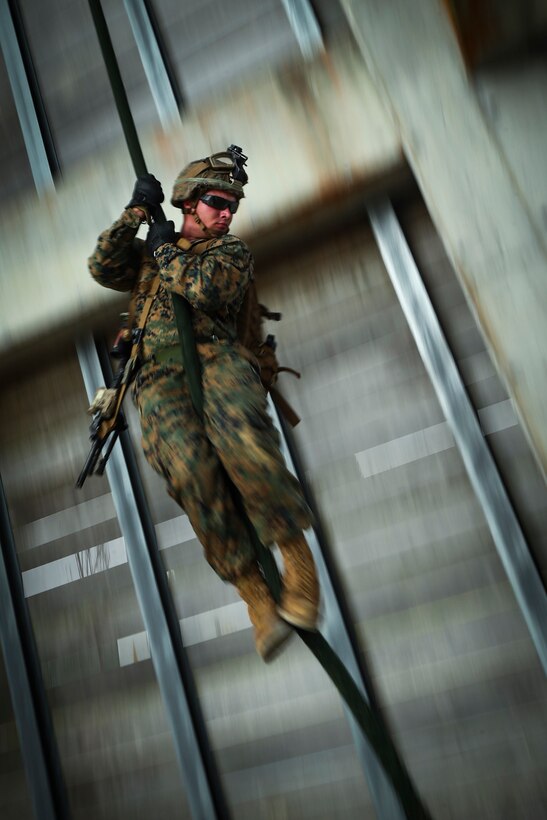 U.S. Marine Corps Lance Cpl. Thomas C. Baggett, from Greenville, Kentucky and a rifleman assigned to Alpha Company, 1st Battalion, 3rd Marine Regiment, fast ropes during Helicopter Rope Suspension Technique (HRST) and rappel training aboard Camp Hansen, Okinawa, Japan, June 20, 2017. The rappel tower prepares Marines to utilize insertion techniques for future operations. The Hawaii-based battalion is forward deployed to Okinawa, Japan as part of the Unit Deployment Program. (U.S. Marine Corps photo by Cpl. Aaron S. Patterson/Released)