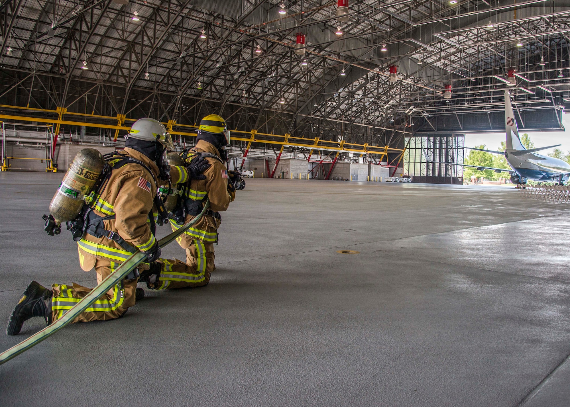 William Johnson, 375th Civil Engineer Squadron station cheif, and Airman 1st Class Macario Martinez, 375th CES fire fighter, simulate putting out a fire on the flight line during a training exercise at Scott Air Force Base, Ill. on June 22, 2017.The exercise was part of the unit's Airport Rescue and Fire Fighting's training which tests their ability to arrive on scene, fight fires, and provide a rescue path as well as recover or rescue personnel. (U.S. Air Force photo by Airman 1st Class Daniel Garcia)