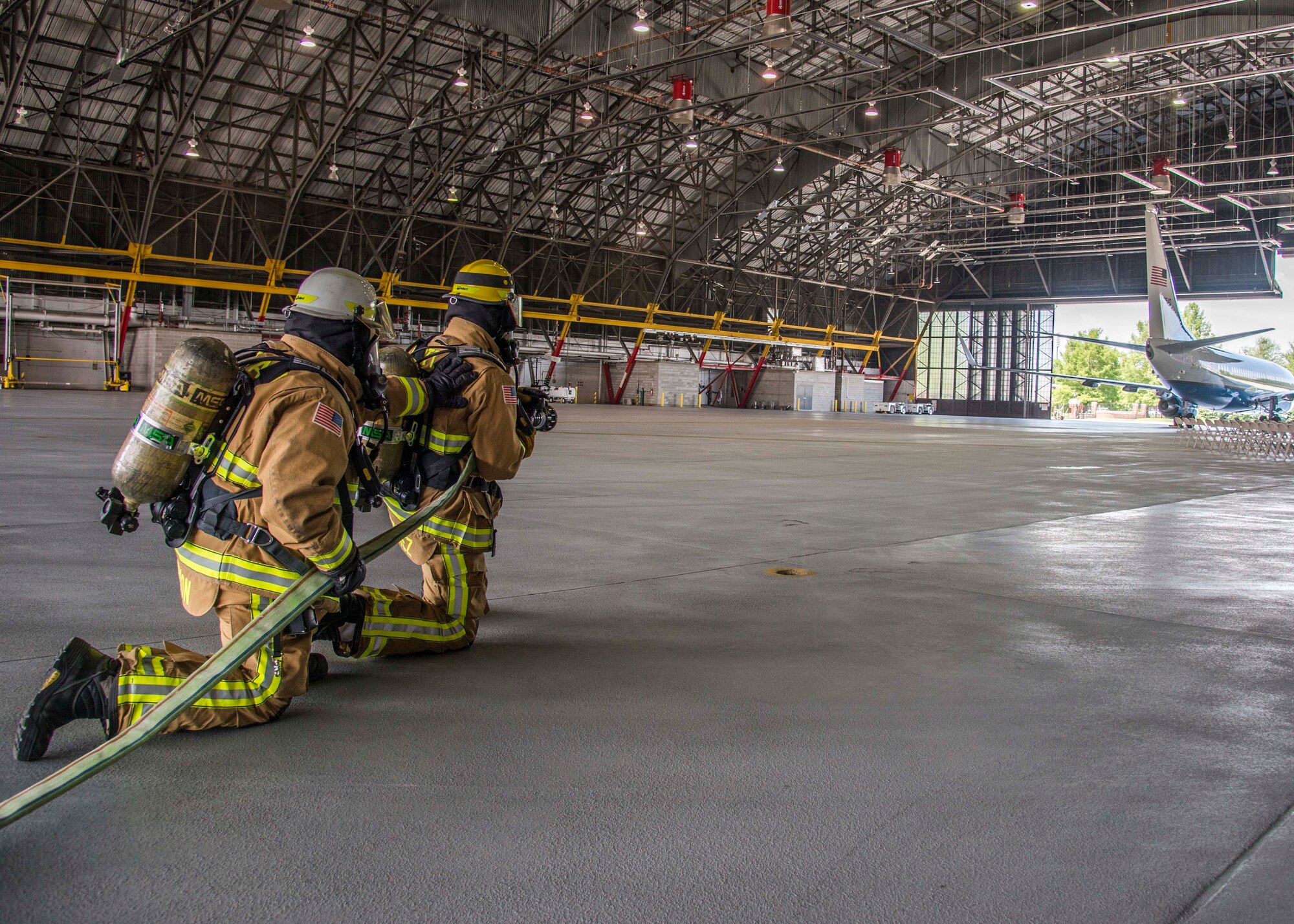 William Johnson, 375th Civil Engineer Squadron station cheif, and Airman 1st Class Macario Martinez, 375th CES fire fighter, simulate putting out a fire on the flight line during a training exercise at Scott Air Force Base, Ill. on June 22, 2017.The exercise was part of the unit's Airport Rescue and Fire Fighting's training which tests their ability to arrive on scene, fight fires, and provide a rescue path as well as recover or rescue personnel. (U.S. Air Force photo by Airman 1st Class Daniel Garcia)