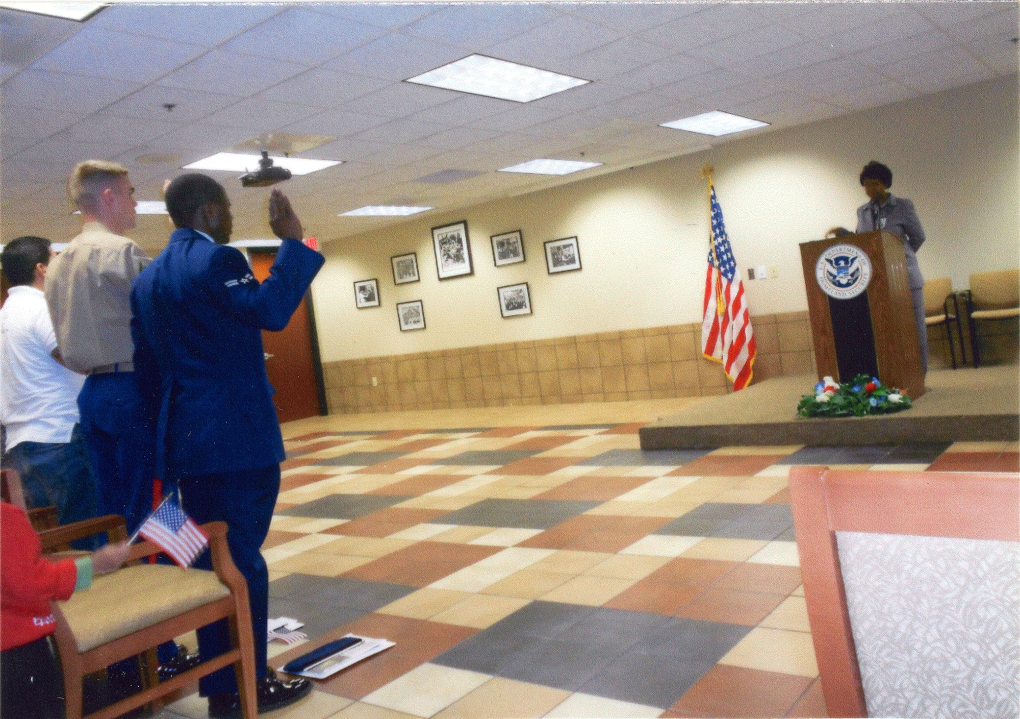 Then U.S. Air Force Airman 1st Class Tinashe Machona, assigned to the 116th Air Control Wing, takes the Oath of Allegiance, during a citizenship ceremony in Atlanta, Ga., Jan. 12, 2012. Subsequent to the oath, Machona became a naturalized U.S. Citizen. (Courtesy photo, 2nd Lt. Tinashe Machona)