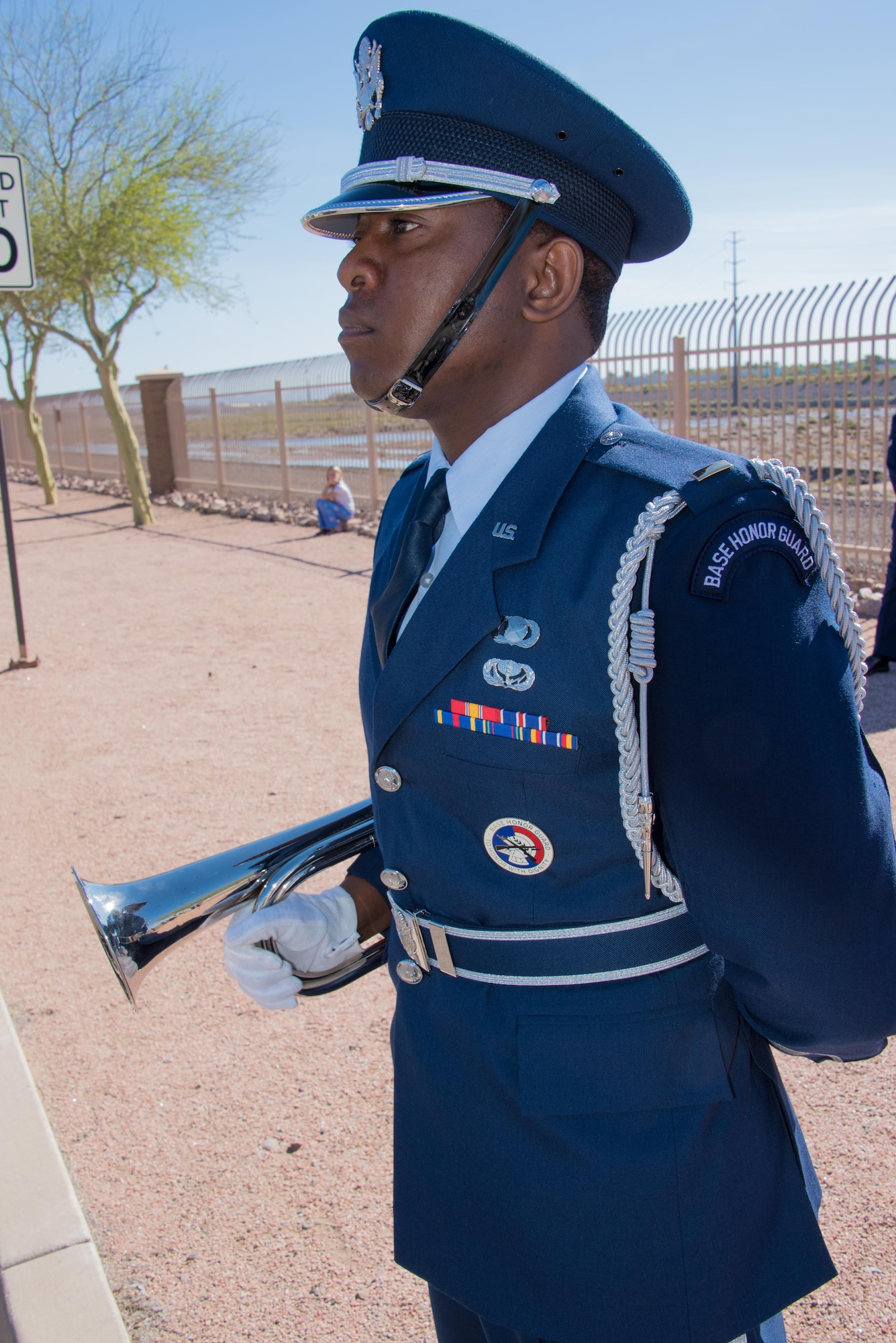 U.S. Air Force 2nd Lt. Tinashe Machona, assigned to the 161st Air Refueling Wing, stands at attention in a color guard detail before playing taps on his trumpet during Copper 5, an air crew memorial ceremony, at Goldwater Air National Base, Phoenix Ariz., March 13, 2017. Machona was the recipient of the 2016 Maj. Gen. Donald L. Owens Junior Officer of the year award at the wing. (U.S. Air National Guard photo by Staff Sgt. Wesley Parrell)