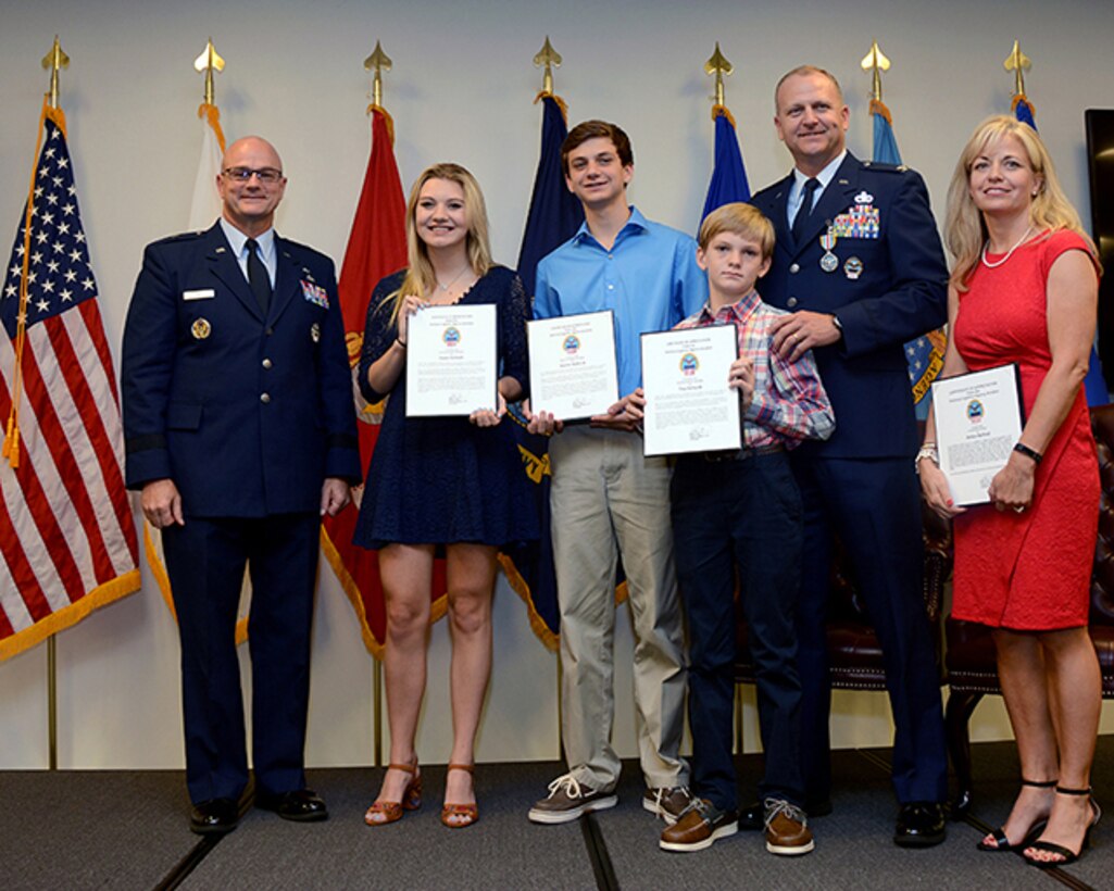 Air Force Col. Kenton Ruthardt’s family, wife Missy, daughter Taylor, sons Keaton and Trey, receive letters of apprectiation from former DLA Aviation Commander Air Force Brig. Gen. Allan Day. Day retired Ruthardt during a ceremony held at the Tinker Aerospace Complex, Tinker Air Force Base, Oklahoma, June 23, 2017.  (Photo by Army Sgt. Saul Rosa)