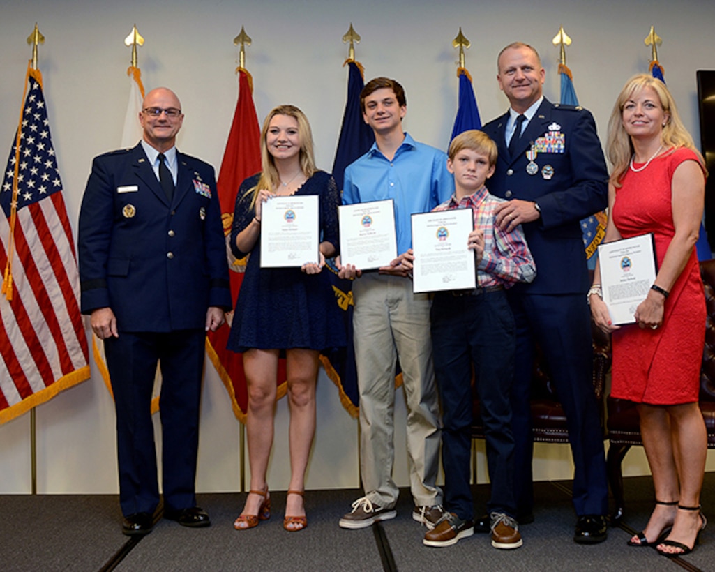 Air Force Col. Kenton Ruthardt’s family, wife Missy, daughter Taylor, sons Keaton and Trey, receive letters of apprectiation from former DLA Aviation Commander Air Force Brig. Gen. Allan Day. Day retired Ruthardt during a ceremony held at the Tinker Aerospace Complex, Tinker Air Force Base, Oklahoma, June 23, 2017.  (Photo by Army Sgt. Saul Rosa)