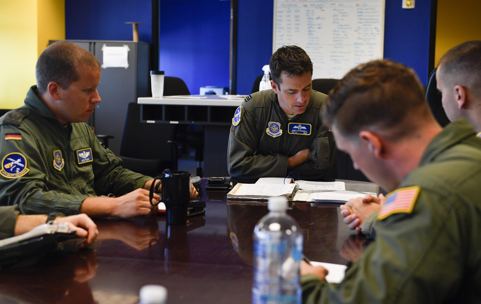 Aircrew members assigned to the 14th and 15th Airlift Squadrons, participating in the foreign exchange pilot program, discuss mission details prior to a flight here June 26, 2017. The program strives to promote mutual understanding and trust, enhance interoperability, strengthen air force to air force ties, and develop long-term professional and personal relationships between partnered countries.