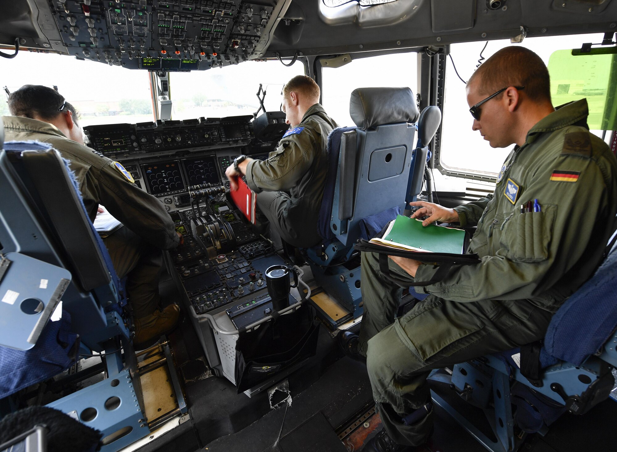 Aircrew members, assigned to the 14th and 15th Airlift Squadrons, participating in the foreign exchange pilot program discuss mission details prior to a flight here June 26, 2017. The program strives to promote mutual understanding and trust, enhance interoperability, strengthen air force to air force ties, and develop long-term professional and personal relationships between partnered countries.