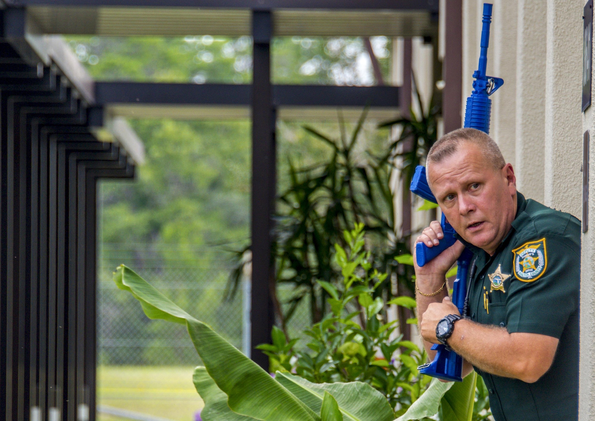 Deputy Ross Richards, Walton County Sheriff’s Office, responds to a report of shots fired at the 20th Space Control Squadron during active shooter training at site C-6 Eglin Air Force Base, Fla., June 27. Geographically separated from Eglin main by 25 miles, responding to incidents creates a challenge for the 96th Security Forces Squadron. The base unit has an agreement with WCSO to respond to any site C-6 emergency. Walton County Sheriff deputies and first responders from Eglin participated in the joint exercise to improve local active shooter processes, communication, and response coordination. (U.S. Air Force photo/Kristin Stewart)