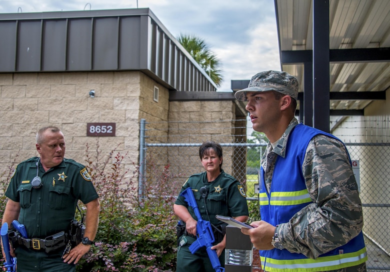 1st Lt. Dominic Vicino, 20th Space Control Squadron crew commander and active shooter training coordinator, discusses processes and response coordination with two members of the Walton County Sheriff’s Office during active shooter training at Eglin Air Force Base, Fla., June 27. Located 25 miles from Eglin main, site C-6 relies on WCSO deputies to rapidly respond to life-threatening situations. (U.S. Air Force photo/Kristin Stewart)