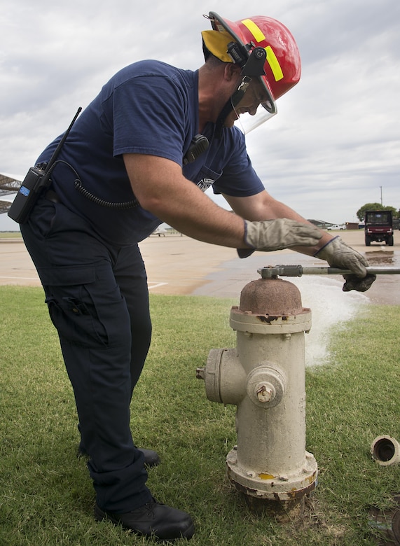 Wes Felber, a base firefighter, closes a fire hydrant June 24 on the flight line. This yearly test insures the fire hydrants are in working order and meet National Fire Protection Association's requirements. (U.S. Air Force photo/ Airman 1st Class Taylor Crul)