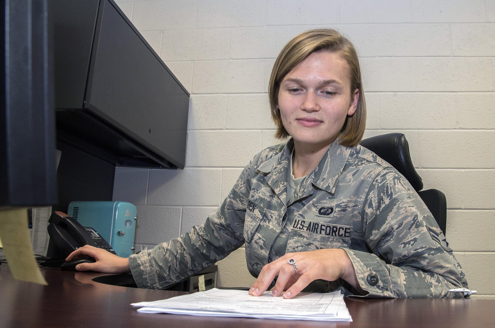 Airman 1st Class Bridget Golden, 502nd Comptroller squadron cashier, assists a customer with military pay June 23, at JBSA-Lackland. 
