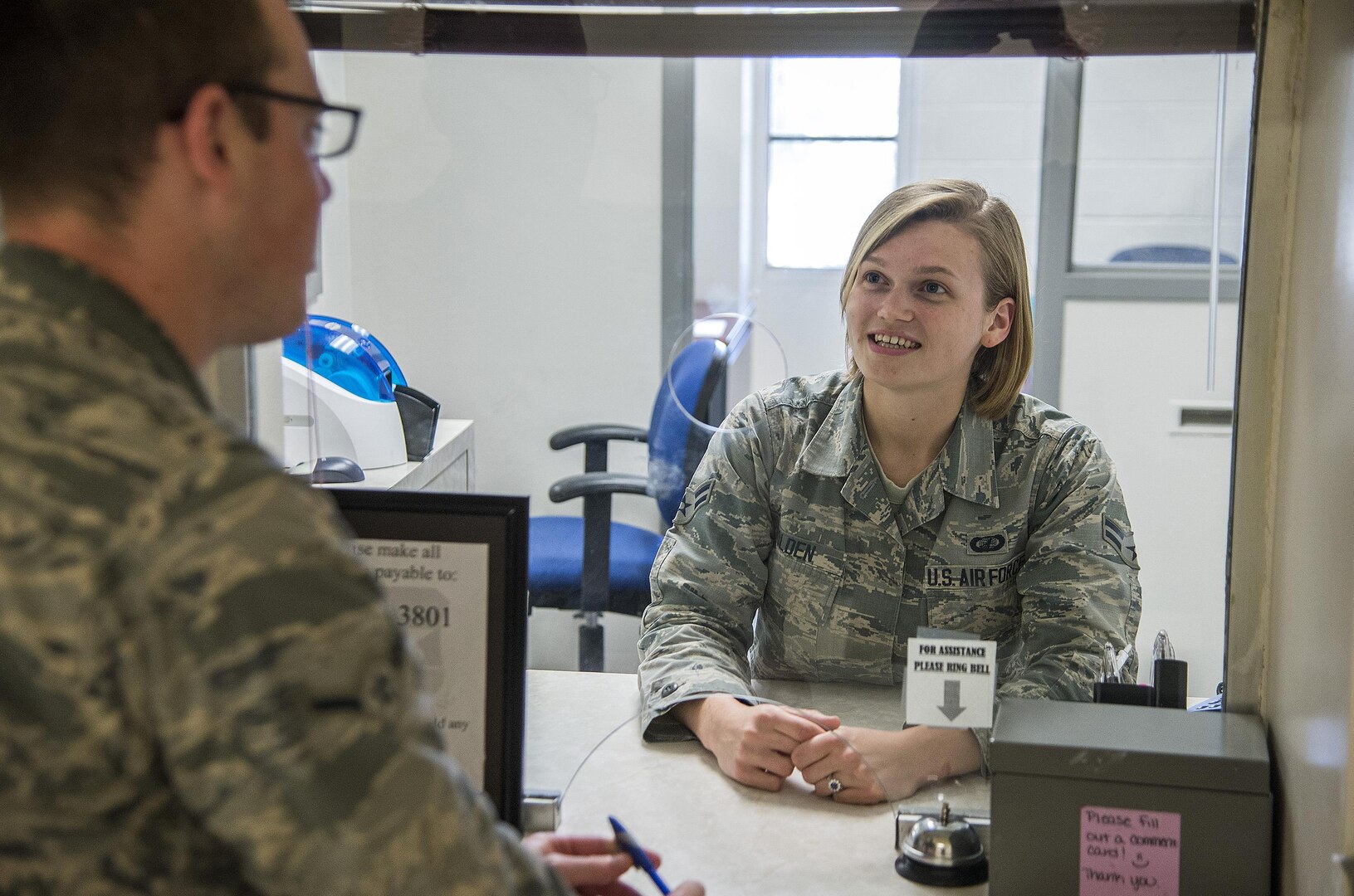 Airman 1st Class Bridget Golden, 502nd Comptroller squadron cashier, assists a customer with military pay June 23, at JBSA-Lackland. 
