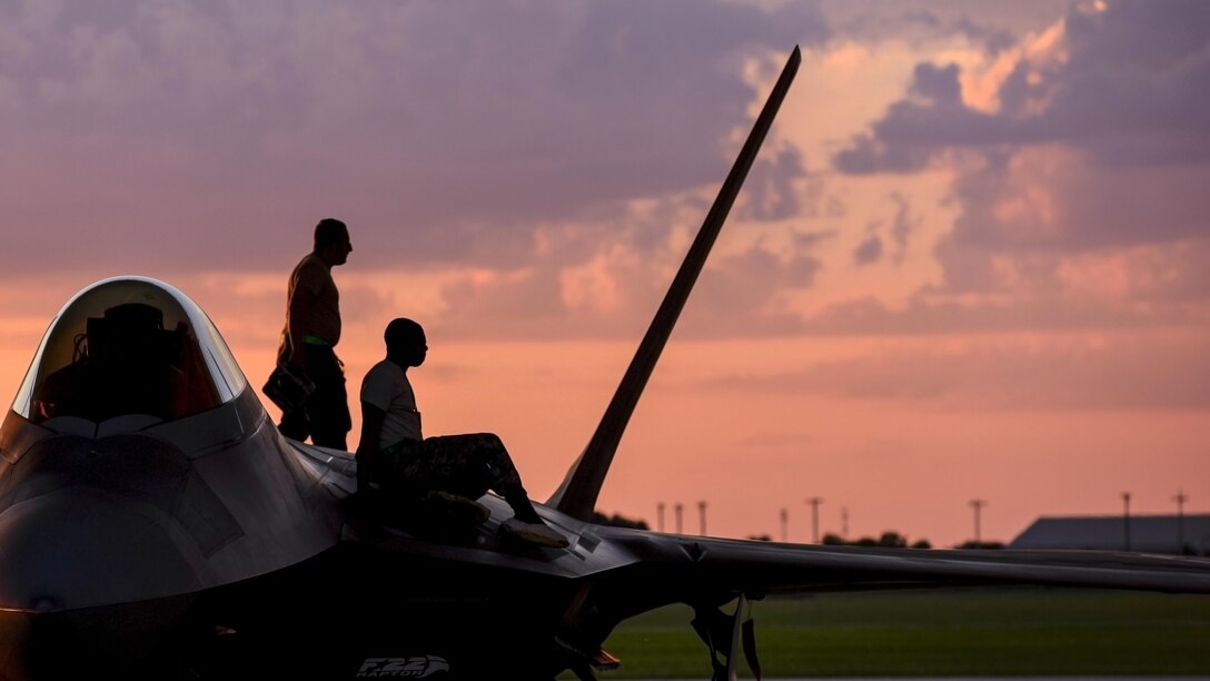Airmen inspect the top of an F-22 Raptor at Joint Base Langley-Eustis, Va., June 26, 2017. The airmen are assigned to the 94th Aircraft Maintenance Unit. Air Force photo by Airman 1st Class Tristan Biese