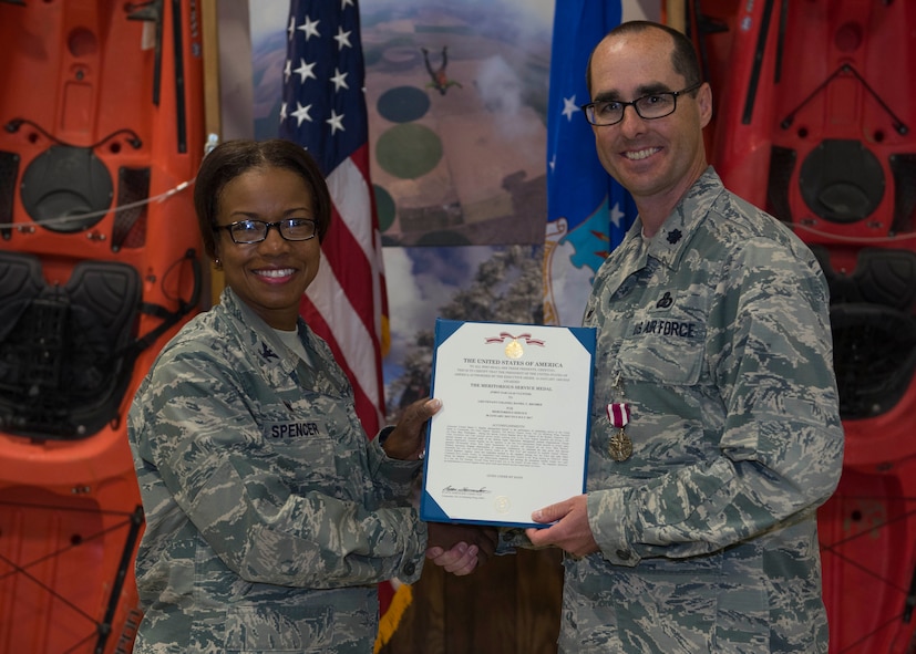 Col. Yvonne Spencer, 92nd Mission Support Group commander, bestows a Meritorious Service Medal to Lt. Col.Daniel Rigsbee, former 92nd Force Support Squadron commander, during the FSS change of command ceremony June 27, 2017, at Fairchild Air Force Base, Washington. Rigsbee has served the Air Force for 16 years.
