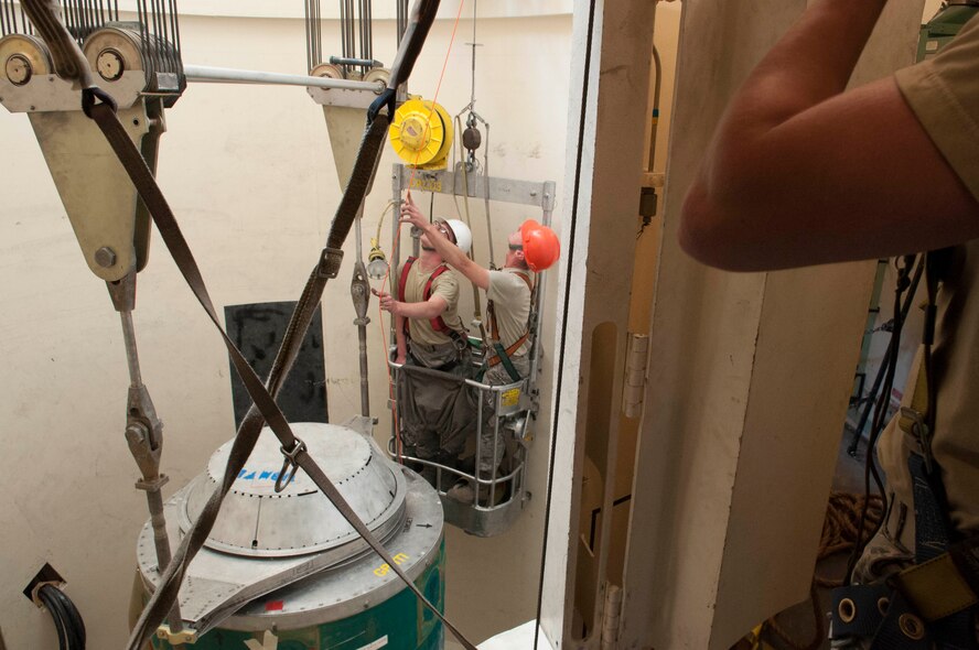 Ninetieth Missile Maintenance Squadron maintainers inspect a hoist in the 90th Missile Wing missile complex, June 6, 2017. The maintainers waited for the missile to come to a stop before going down to connect sling rods to the missile. The missile was removed to comply with the New START Treaty agreement with Russia.  The Air Force met their NST requirements when the 50th Minuteman III Intercontinental Ballistic Missile was removed from a silo in the 90th MW missile complex. (U.S. Air Force photo by Airman 1st Class Breanna Carter)