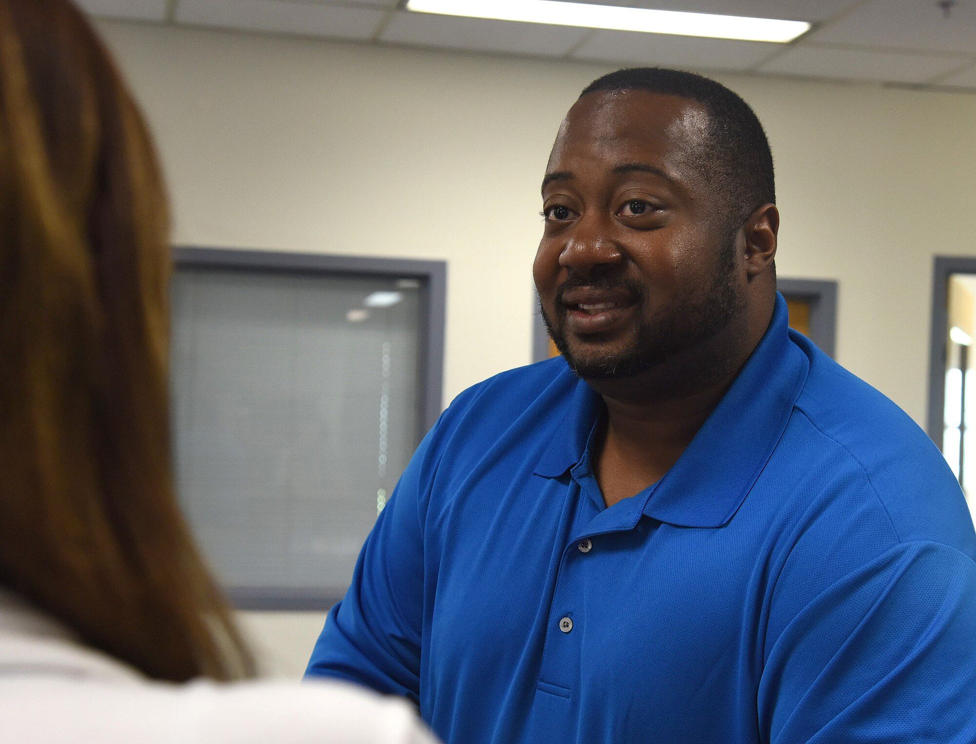 Shawn Belk, Airman and Family Readiness Center work and life specialist, speaks with a spouse about options afforded to her June 27, 2017, at Malmstrom Air Force Base, Mont. The mission of AFRC is to be available for the needs of the service member, but also support their loved ones. (U.S. Air Force photo/Senior Airman Jaeda Tookes)