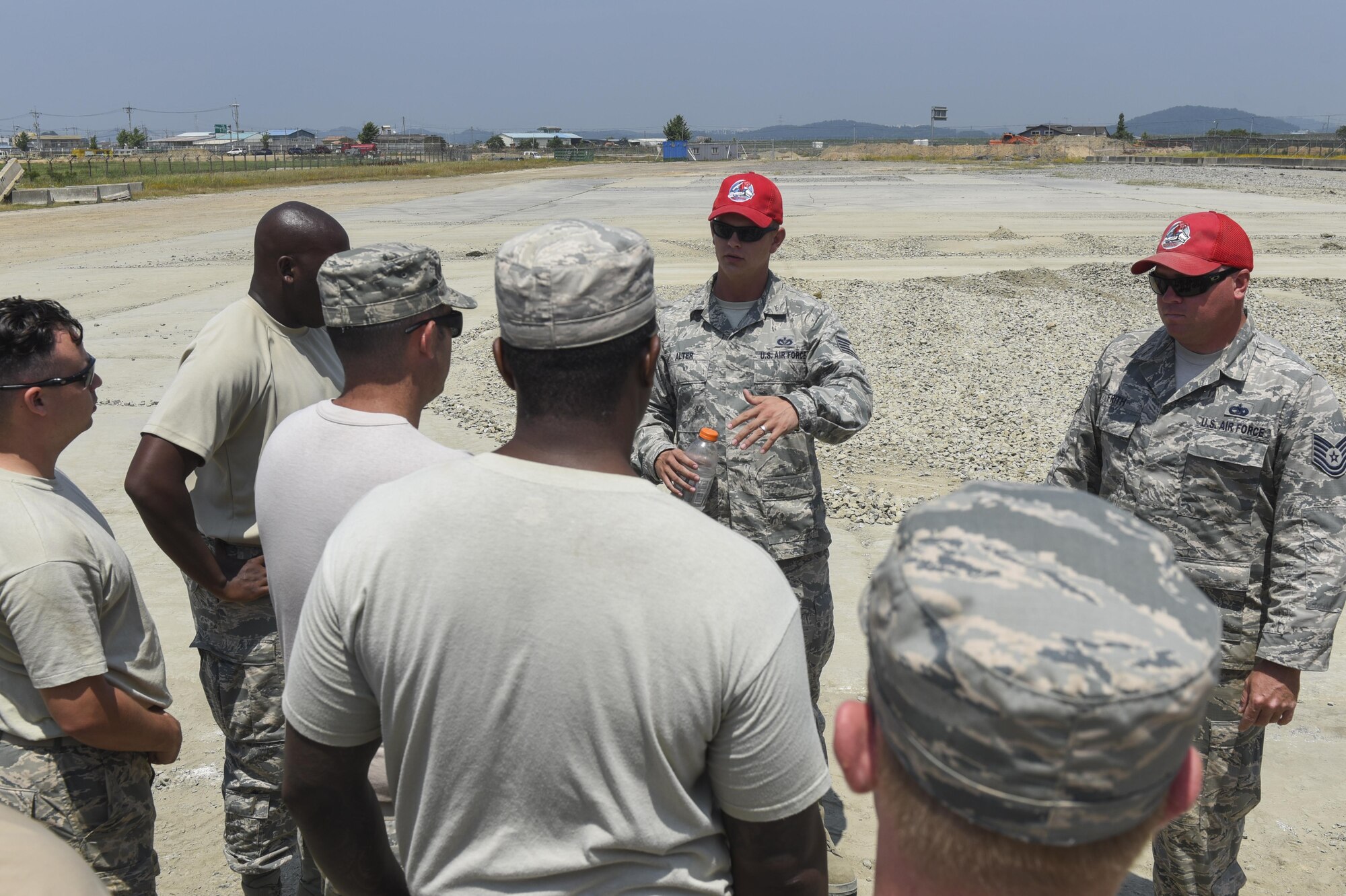 U.S. Air Force Tech. Sgt. Todd Alter, 554th Red Horse Squadron pavements and equipment contingency training NCO in charge, speaks with members of the 8th Civil Engineering Squadron June 23, 2017, Kunsan Air Base, Republic of Korea. The 8th Civil Engineering Squadron participated in airfield damage repair training as part of the final Exercise Silver Flag training held at Kunsan. U.S. Air Forces Pacific will now focus on ensuring Airmen have their three-year Silver Flag currency, prior to arriving on the Korean Peninsula, instead of conducting the training here. (U.S. Air Force photo by Senior Airman Michael Hunsaker/Released)
