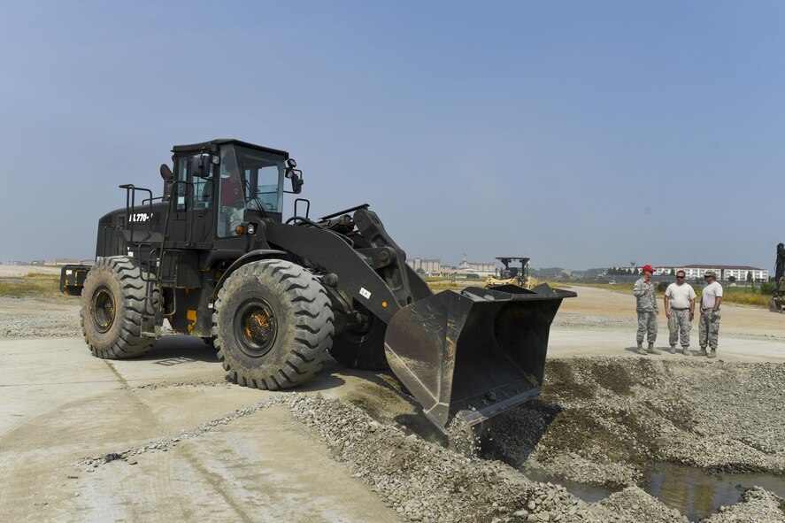 U.S. Air Force Senior Airman Robert Mcintosh, 8th Civil Engineering Squadron pavement and construction journeyman, pushes gravel into a crater using a loader June 23, 2017, Kunsan Air Base, Republic of Korea. The 8th Civil Engineering Squadron participated in airfield damage repair training as part of the final Exercise Silver Flag training held at Kunsan. U.S. Air Forces Pacific will now focus on ensuring Airmen have their three-year Silver Flag currency, prior to arriving on the Korean Peninsula, instead of conducting the training here. (U.S. Air Force photo by Senior Airman Michael Hunsaker/Released)