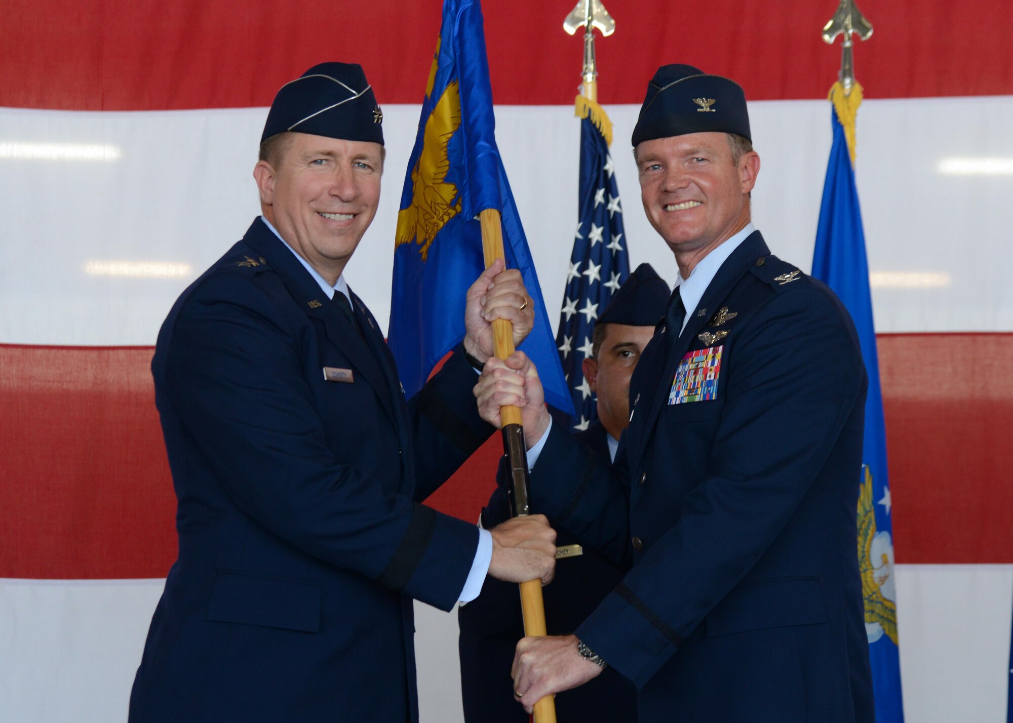 U.S. Air Force Col. Thomas Shank, outgoing 47th Flying Training Wing commander, relinquishes command to Maj. Gen. Patrick Doherty, 19th Air Force commander, during the wing's change of command ceremony at Laughlin Air Force Base, Tx., June 28, 2017. The passing of the guideon symbolizes the ceremonious passing of responsibility and command from one party to another.