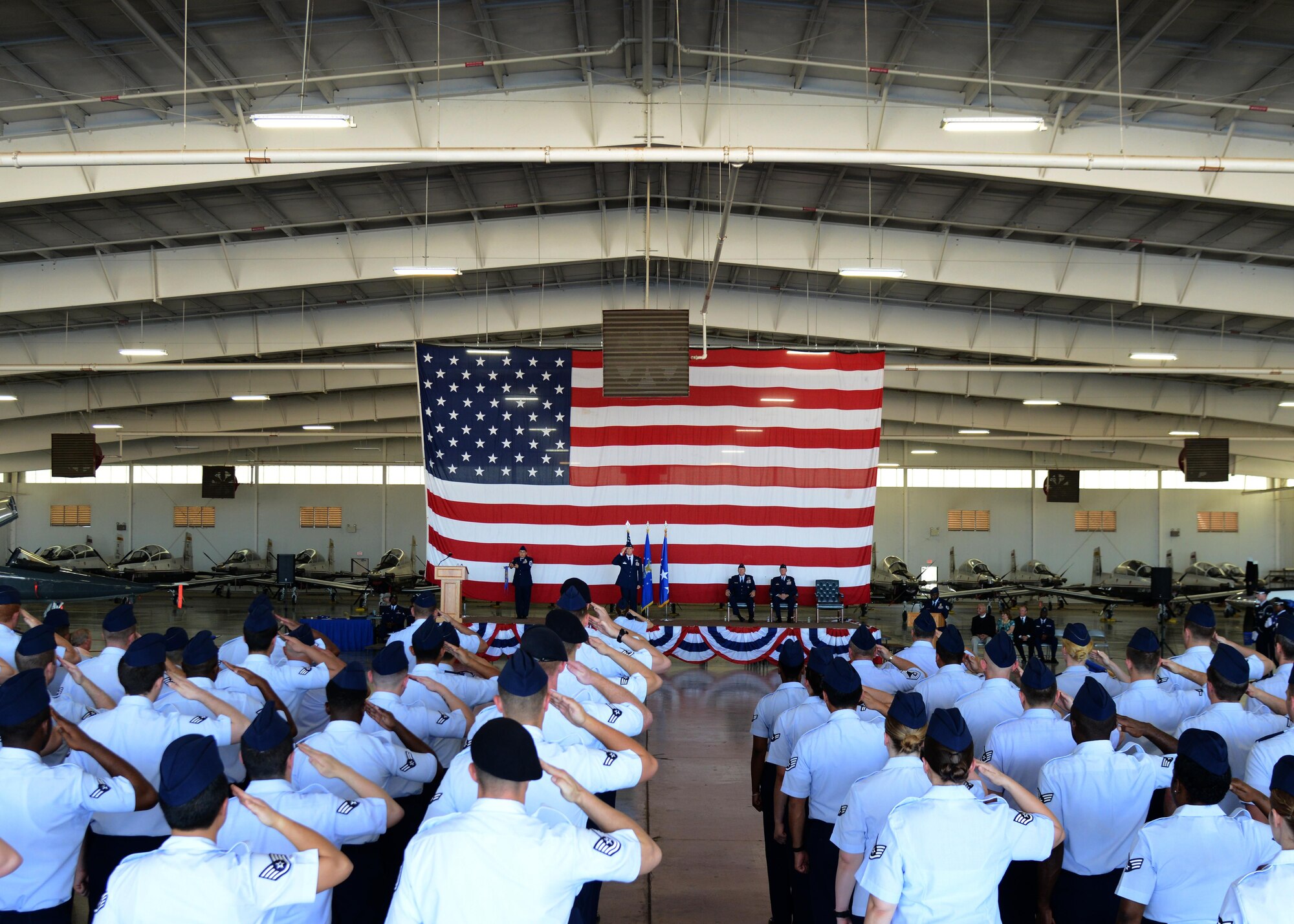 Various groups across Laughlin Air Force Base stand and render a first salute to U.S. Air Force Col. Charles Velino, incoming 47th Flying Training Wing commander, at Laughlin Air Force Base, Tx., June 28, 2017.  Velino assumes command of a base that began its pilot training program in 1947.