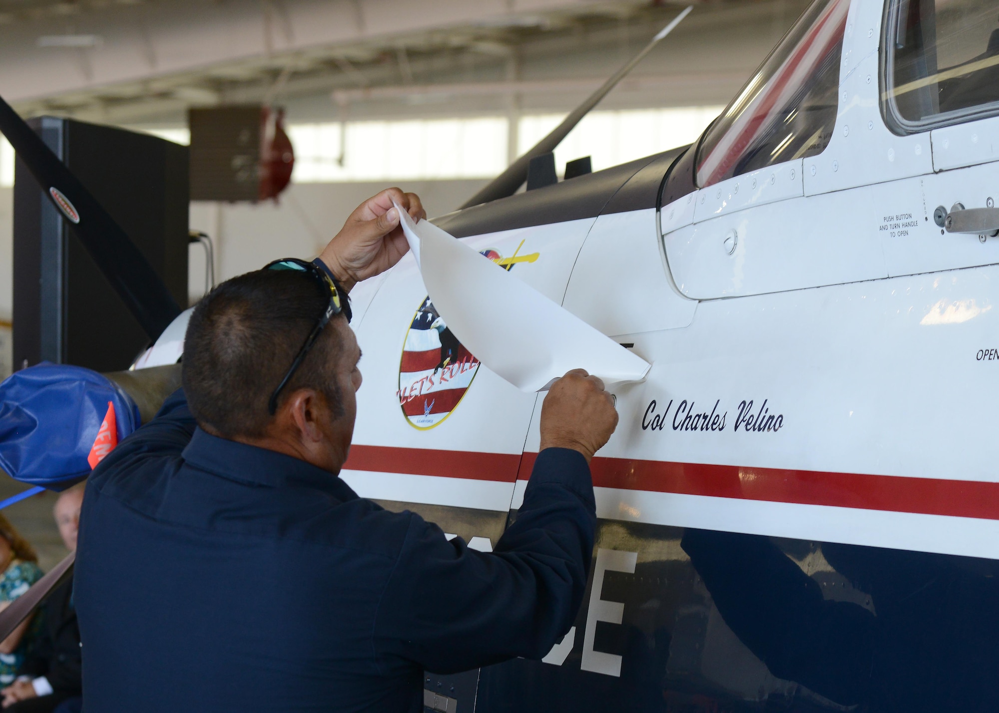 Newly appointed commander of the 47th Flying Training Wing, U.S. Air Force Col. Charles Velino, has his name revealed on the side of a T-6 Texan II during the wing’s change of command ceremony at Laughlin Air Force Base, Tx., June 28, 2017.  The T-6 is the wing’s primary training aircraft, which is flown by all undergraduate pilot students.
