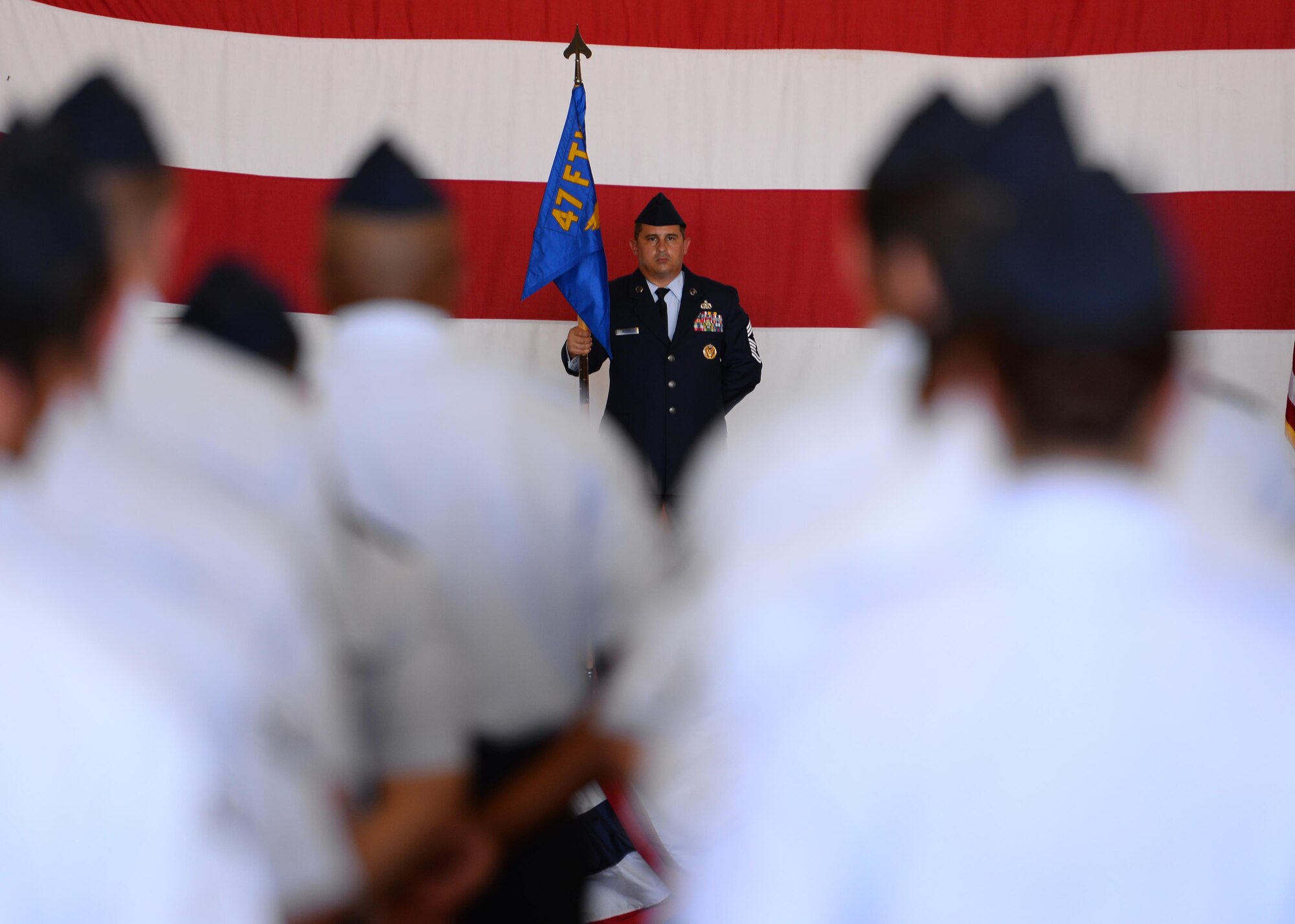 U.S. Air Force Chief Master Sgt. George Richey, 47th Flying Training Wing command chief, stands at ease with the wing’s guideon during the 47th Flying Training Wing’s change of command ceremony at Laughlin Air Force Base, Tx., June 28, 2017.  Chief Richey has served at the operational and strategic leadership levels with positions at the flight, squadron, and Headquarters Air Force levels. 