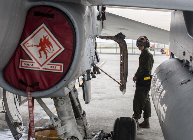 U.S. Marine Corps Lance Cpl. George Gonzalez, a powerline mechanic with Marine Fighter Attack Squadron (VMFA) 232, conducts maintenance on an F/A-18C Hornet during scheduled phase maintenance at Marine Corps Air Station Iwakuni, Japan, June 27, 2017. When aircraft go through phase maintenance, mechanics are able to perform in-depth maintenance to enhance the welfare of the aircraft. The definitive objective of the evaluation is to ensure mission accomplishment and safety of operations around the Indo-Asia Pacific region. (U.S. Marine Corps photo by Lance Cpl. Mason Roy)