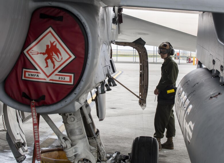 U.S. Marine Corps Lance Cpl. George Gonzalez, a powerline mechanic with Marine Fighter Attack Squadron (VMFA) 232, conducts maintenance on an F/A-18C Hornet during scheduled phase maintenance at Marine Corps Air Station Iwakuni, Japan, June 27, 2017. When aircraft go through phase maintenance, mechanics are able to perform in-depth maintenance to enhance the welfare of the aircraft. The definitive objective of the evaluation is to ensure mission accomplishment and safety of operations around the Indo-Asia Pacific region. (U.S. Marine Corps photo by Lance Cpl. Mason Roy)