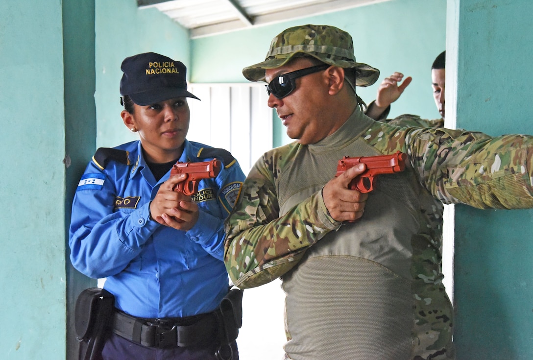 U.S. Army Staff Sgt. Marcos Dejesus, Joint Task Force-Bravo Joint Security Forces, explains tactical movements for clearing rooms to a local police officer at La Paz, Honduras, June 20, 2017. 